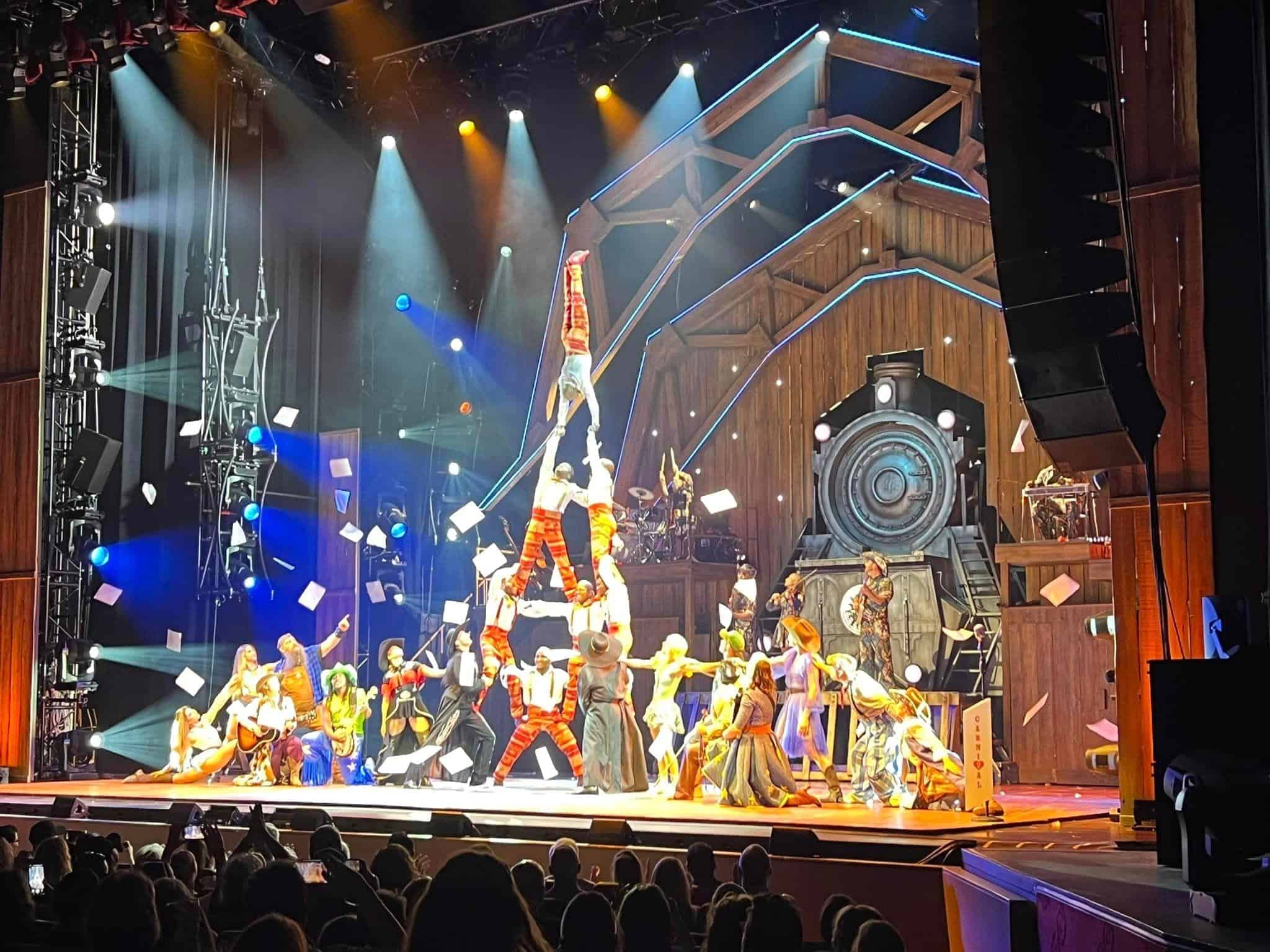 Cirque du Soleil doing a show with acrobats forming a pyramid.