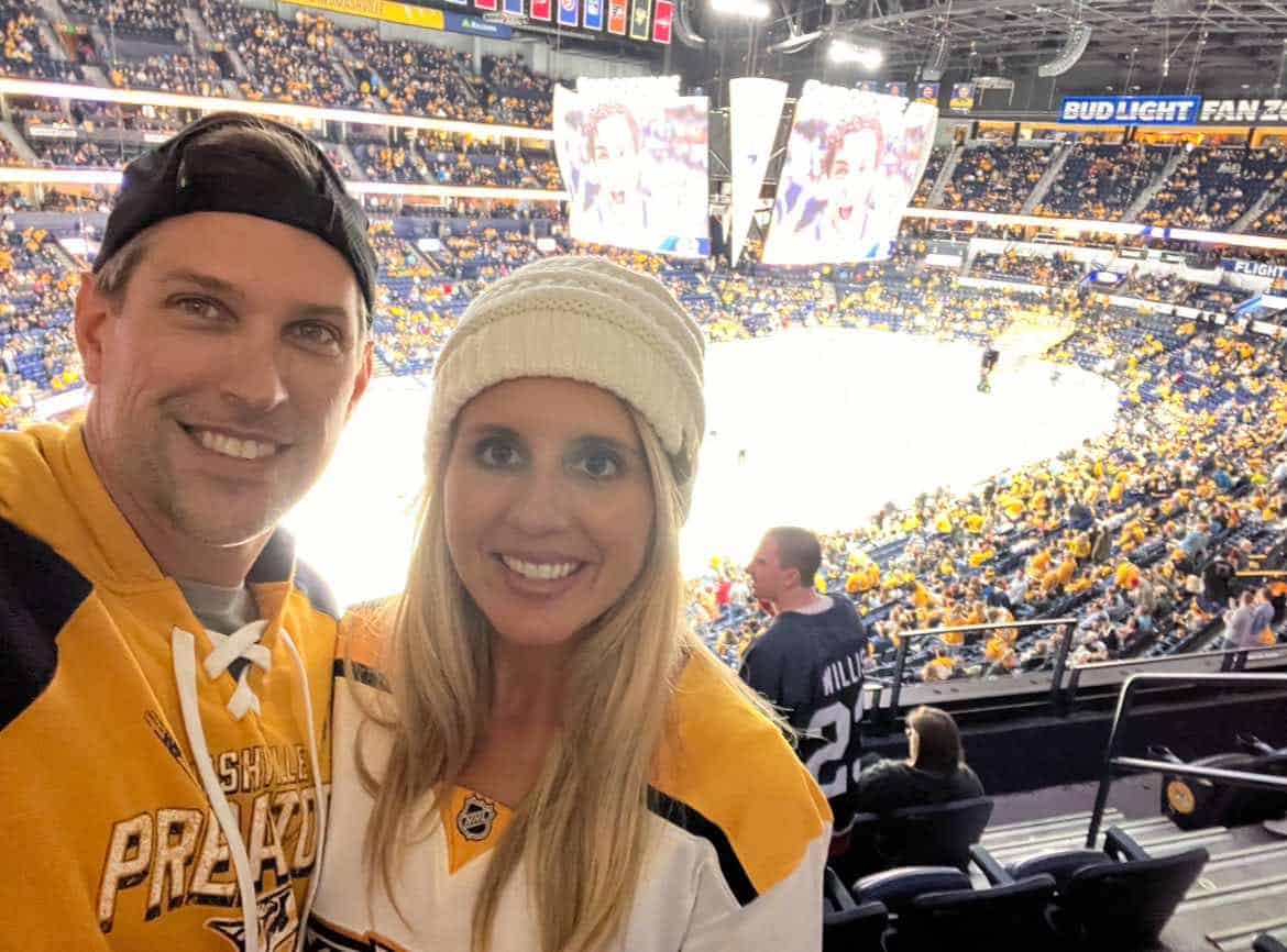 Man and wife at a Nashville Predator's hockey game.