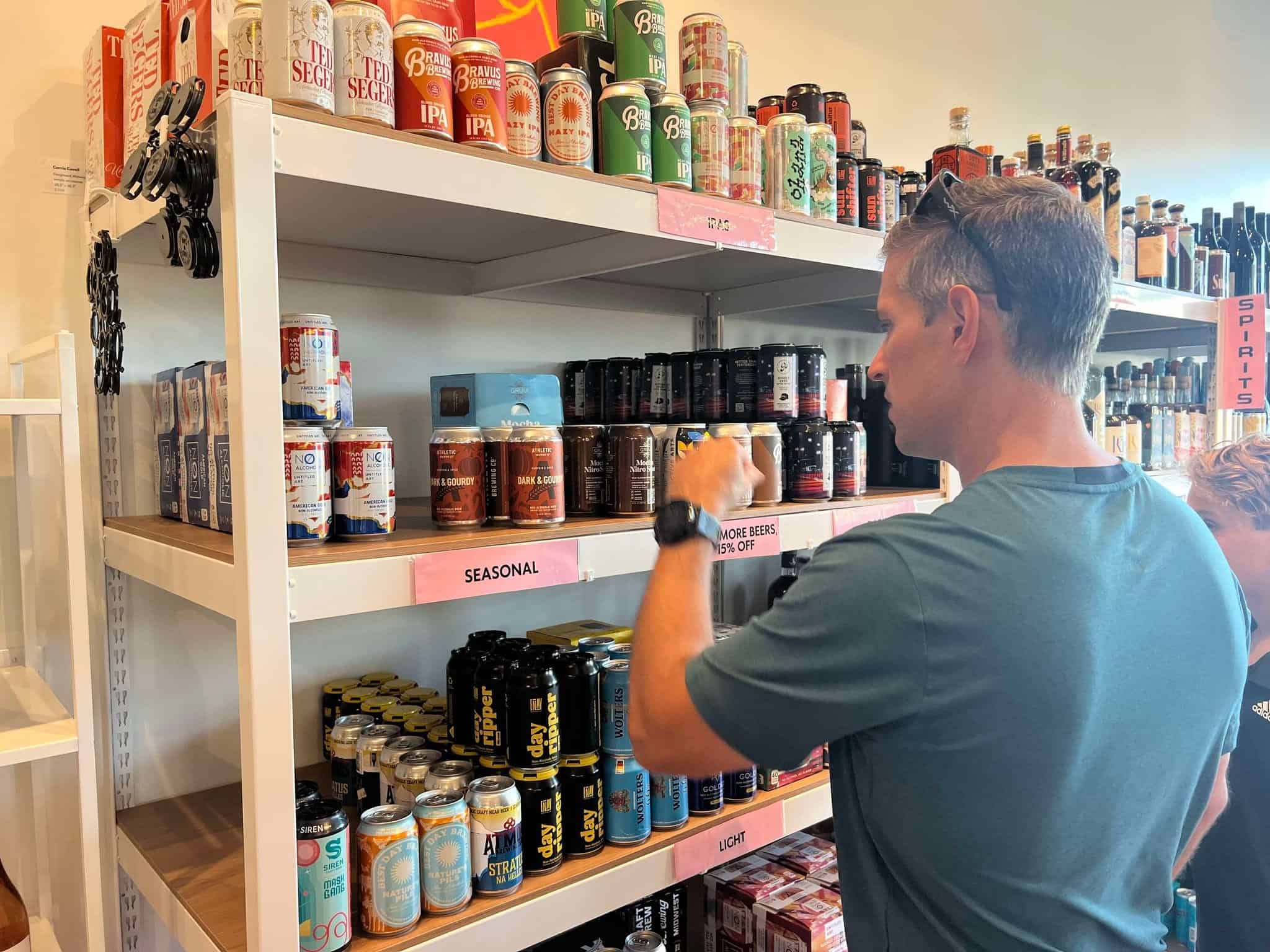 A man looking at the drinks at a store dedicated to non-alcoholic drinks in Nashville.