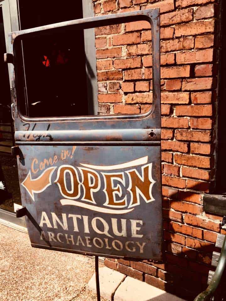 Old car door with the words "Antique Archeology" on it.