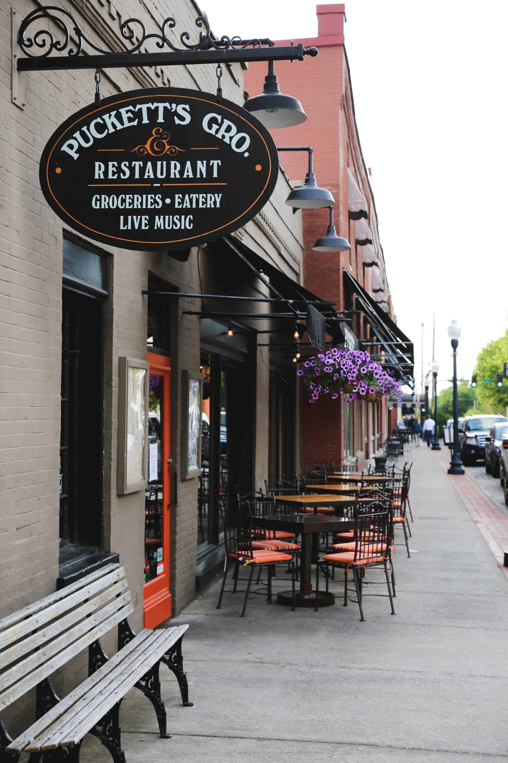 Picture of the outside of Puckett's with outside seating.