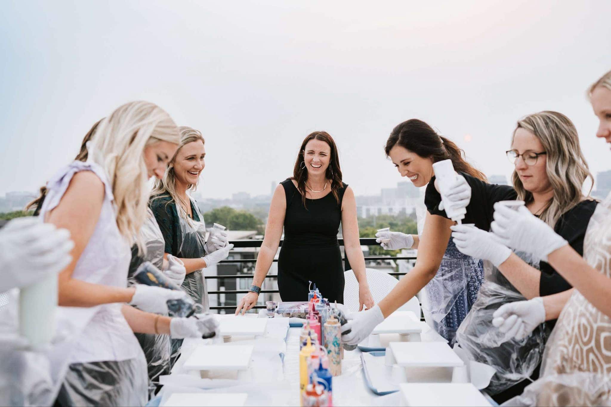 Group of women taking an art class on a rooftop.