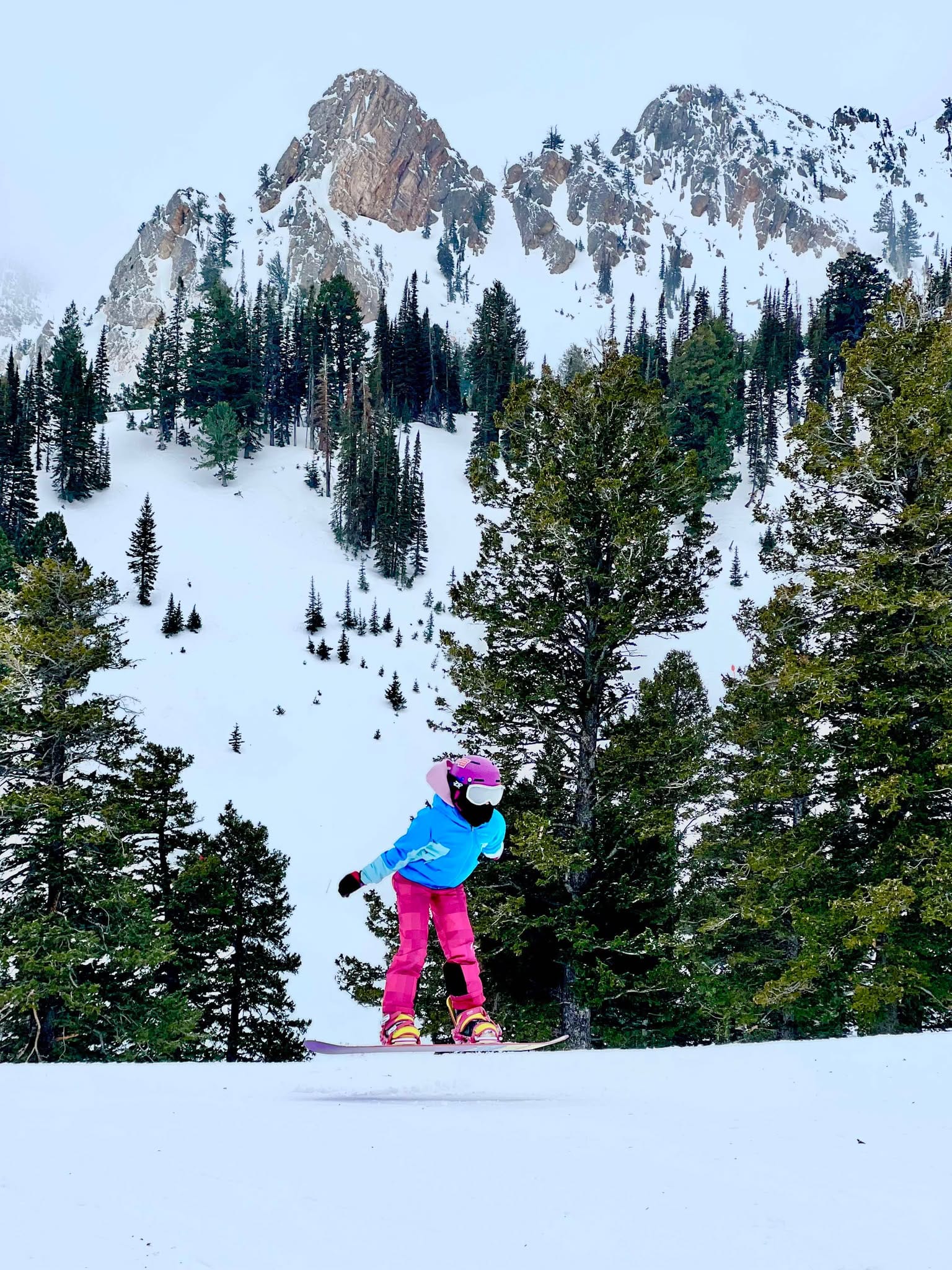 Girl snowboarding during her house swapping trip.