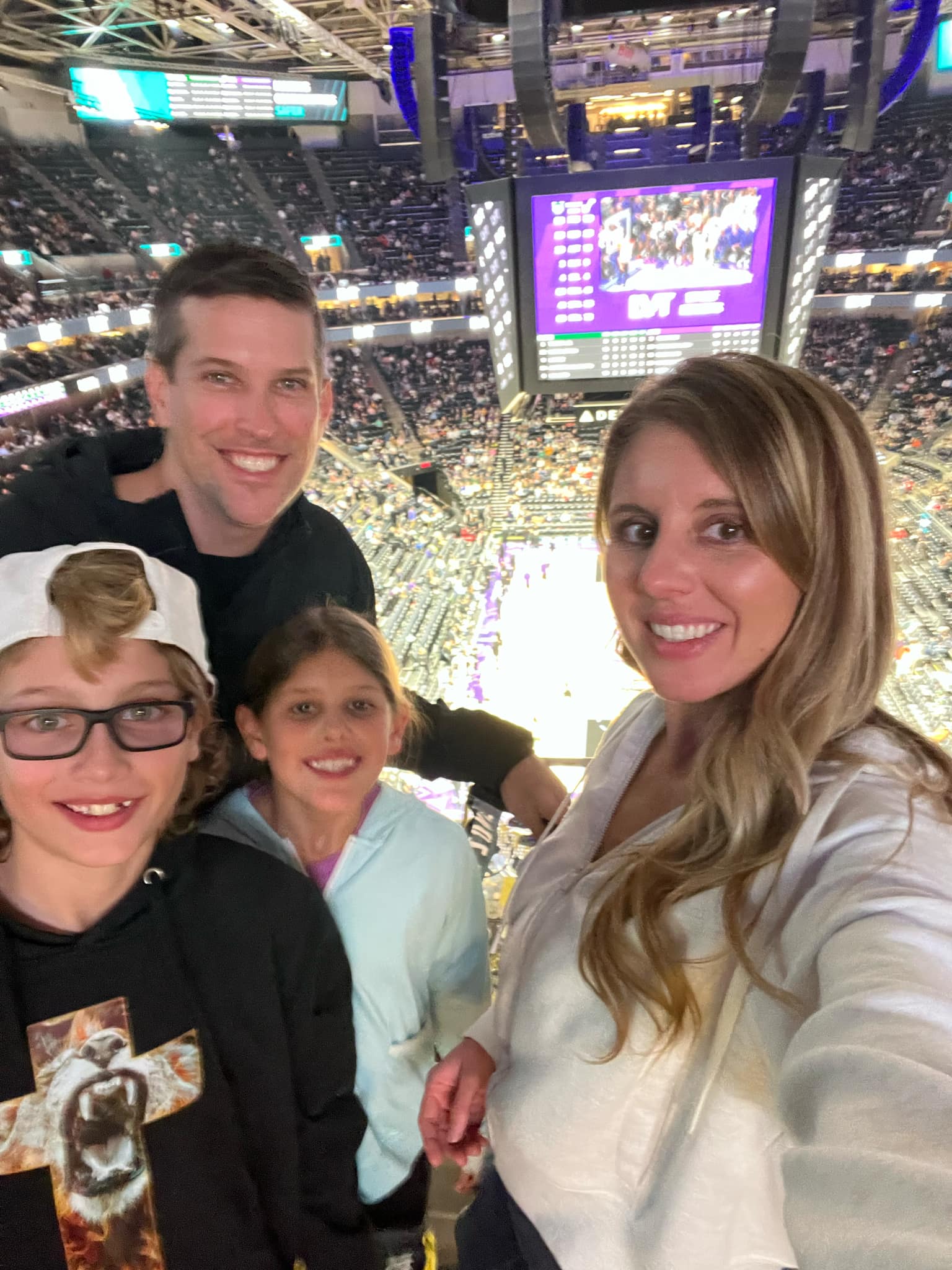 A family at a Jazz Utah basketball game during their family snowboarding trip to Snowbasin Ski Resort.