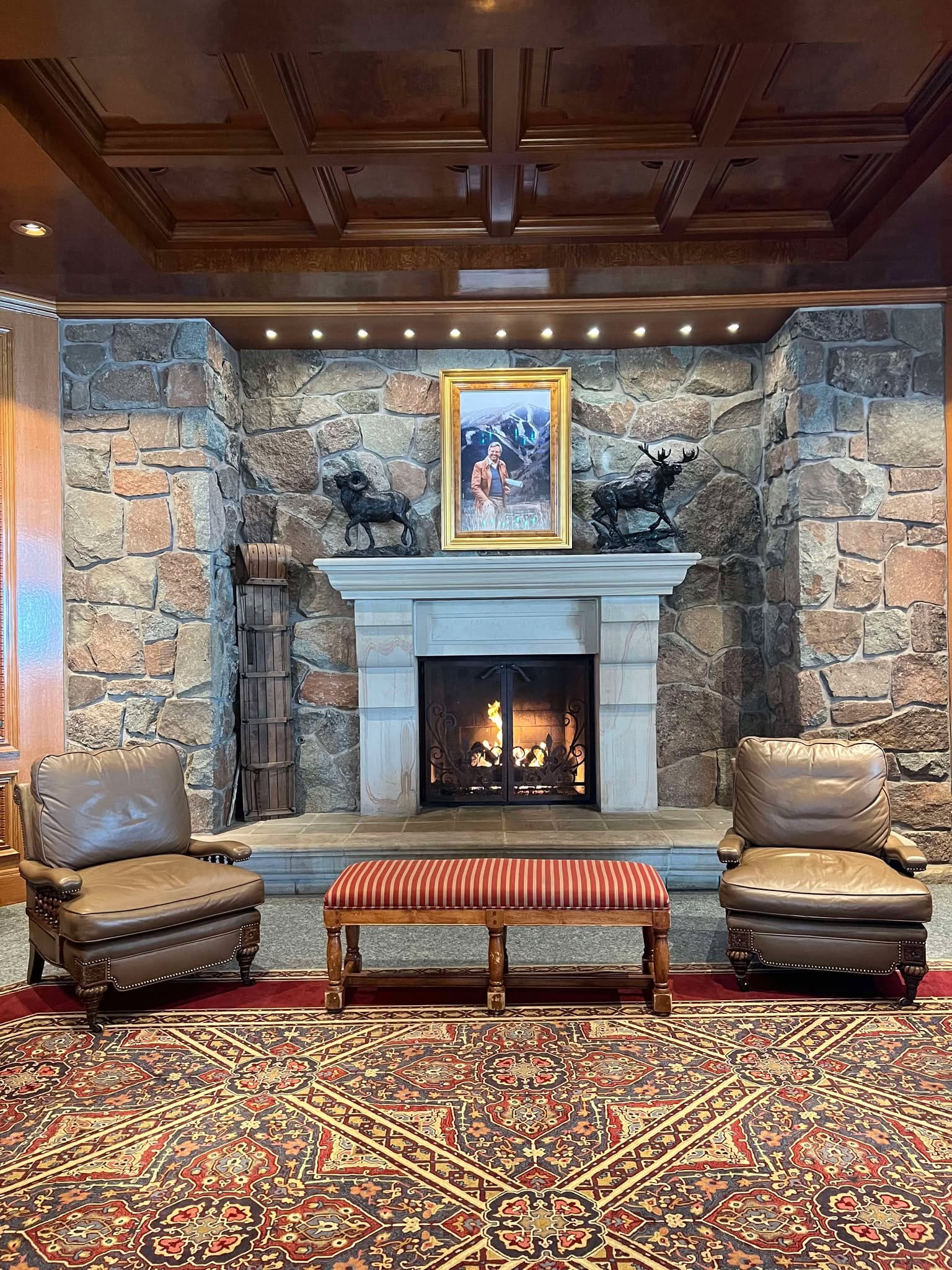 One of the fireplaces with chairs and sofas around it in Earl's Lodge at Snowbasin.