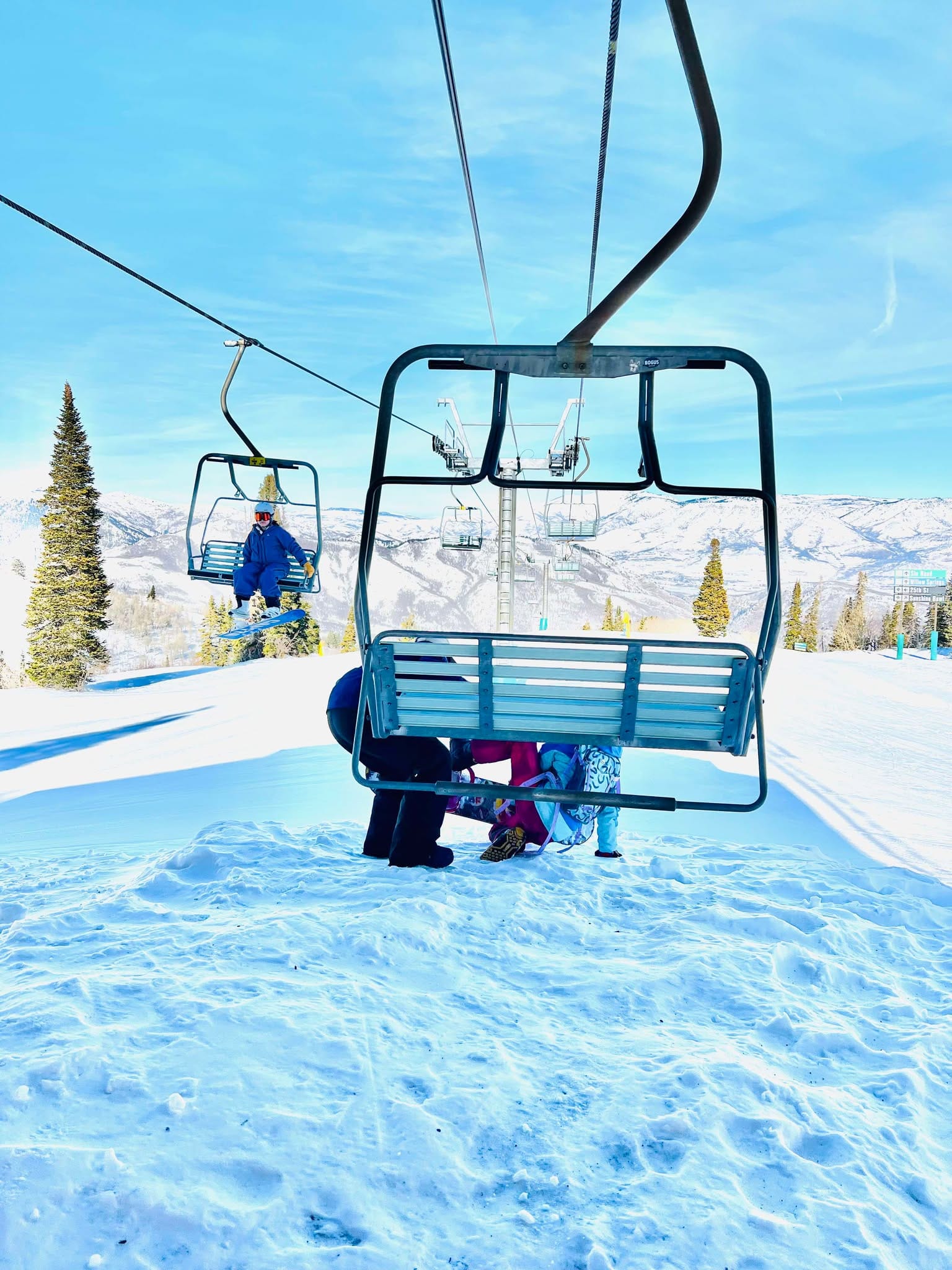 A little girl getting help off the ski lift after getting stuck on it at Snowbasin.