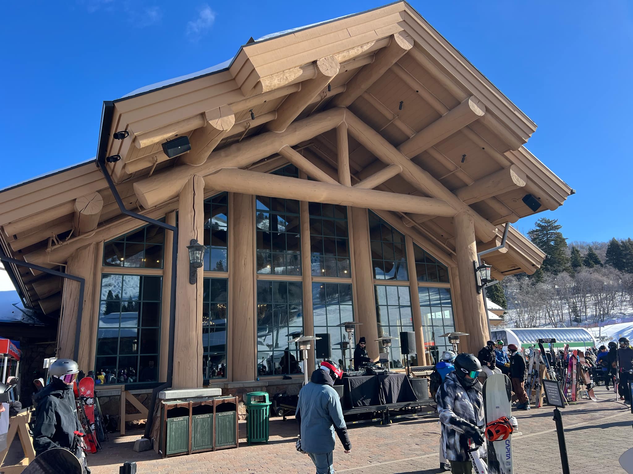 A DJ plays music for the crowd in front of Earl's Lodge at Snowbasin.