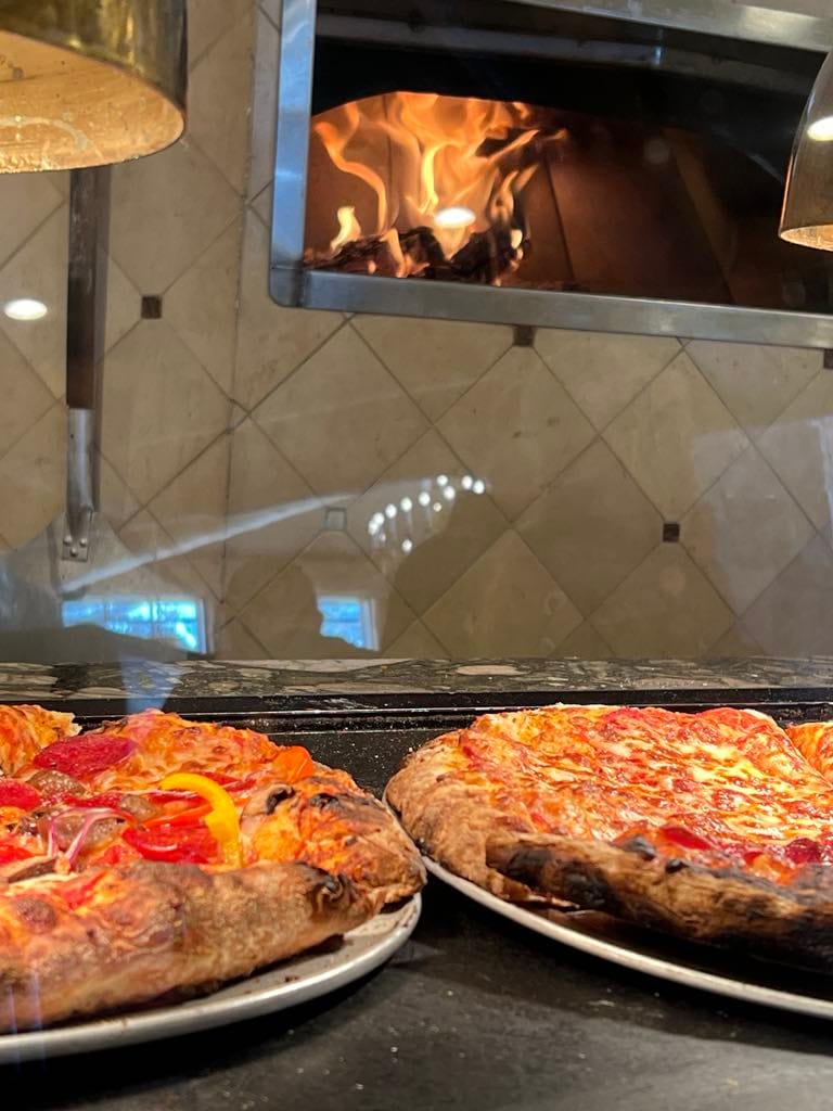 Picture of pizza that is fresh out of the oven at John Paul Lodge.