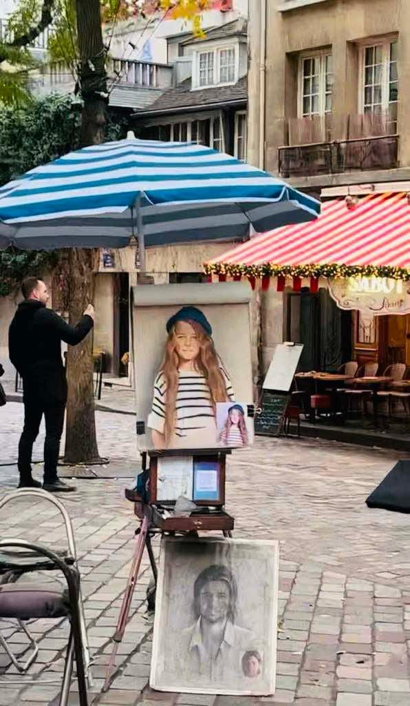 A painting of a girl in a blue and white striped shirt being featured by a Montmartre artist.