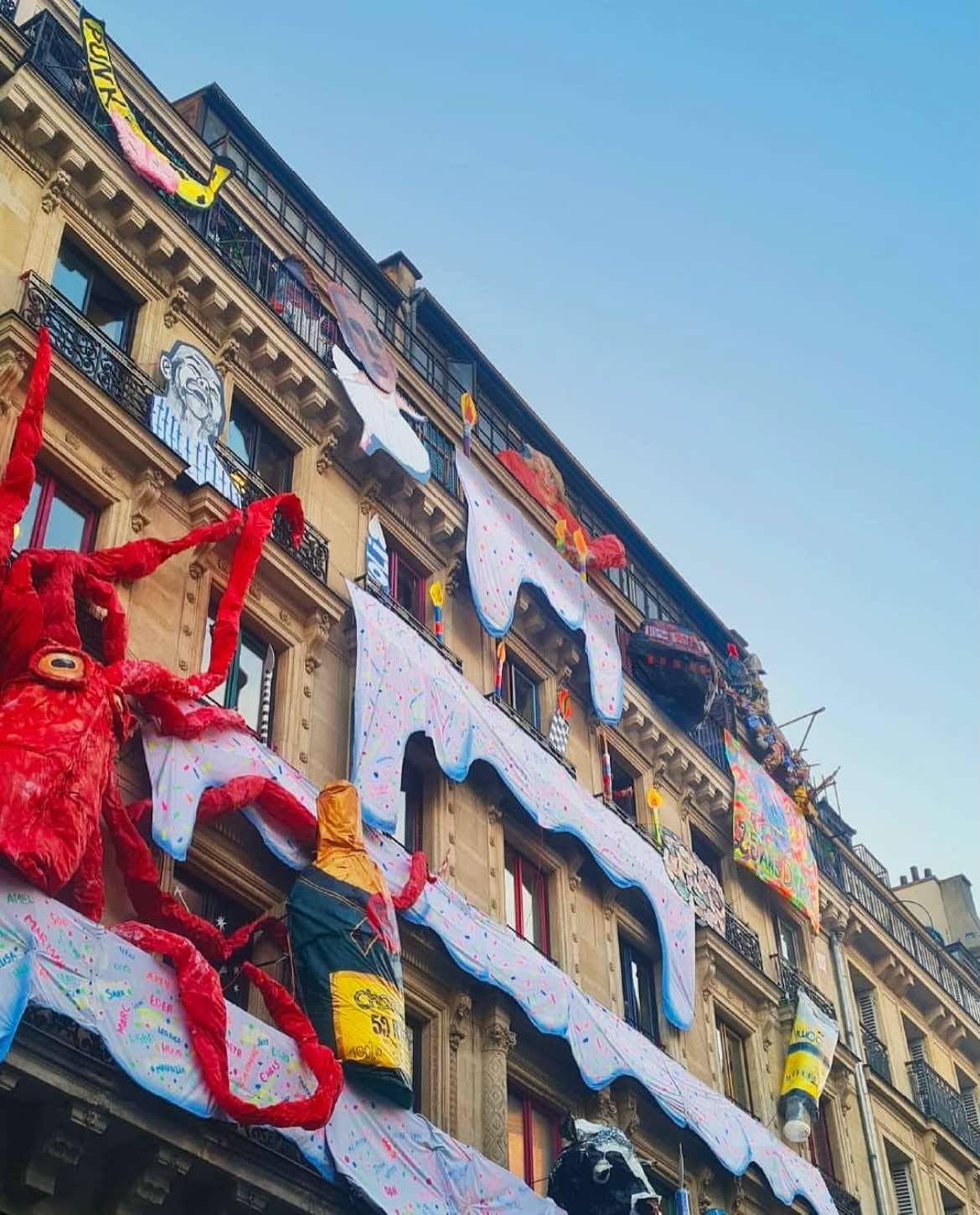 Photo of 59 Rivoli's building with a massive octopus and cake frosting dripping from the building.
