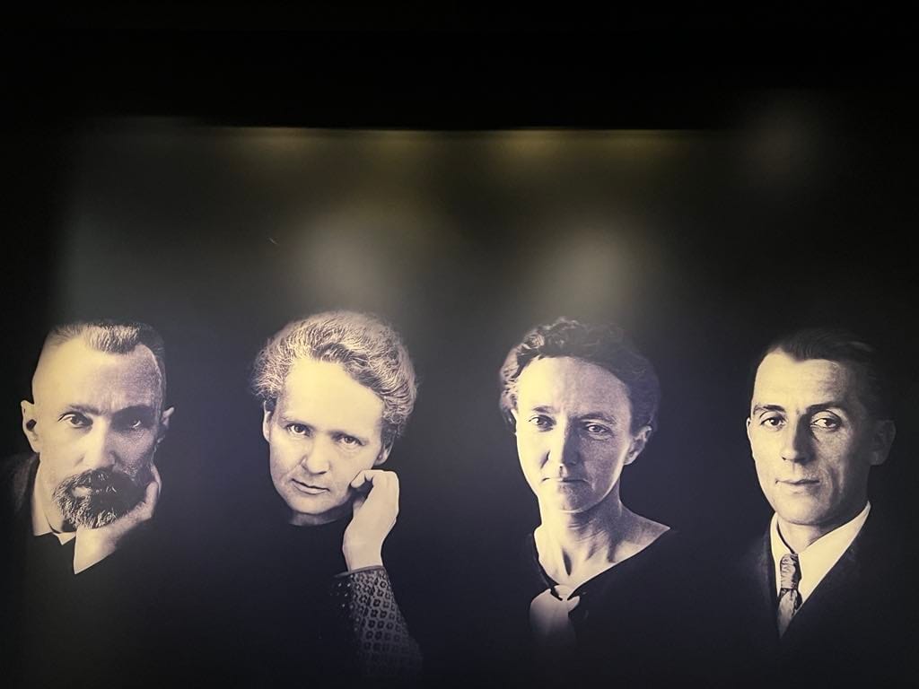 Photo at the Marie Curie museum of Marie Curie and 3 other scientists.