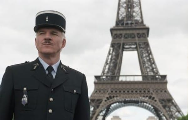 Photo of the police officer standing in front of the Eiffel Tower in the movie Pink Panther.