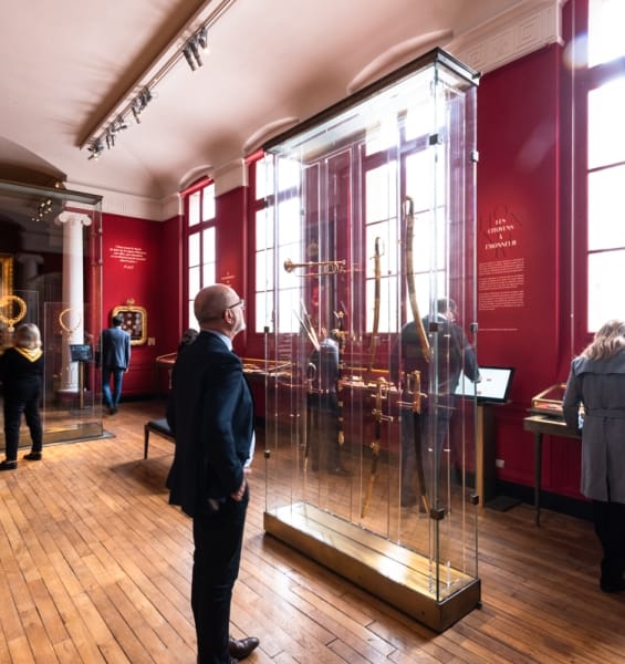 A man admiring a sword at the Grand Chancellery of the Legion of Honour museum.