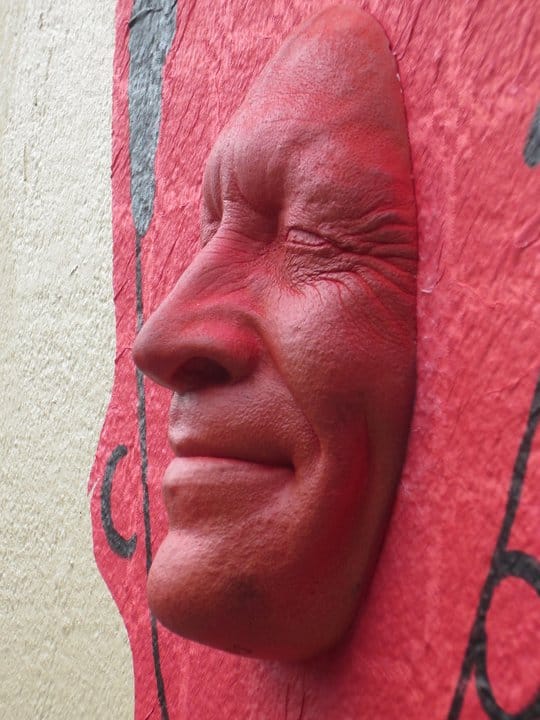 Another piece of art of a face coming out of the cement wall in Montmartre. This face was painted red.