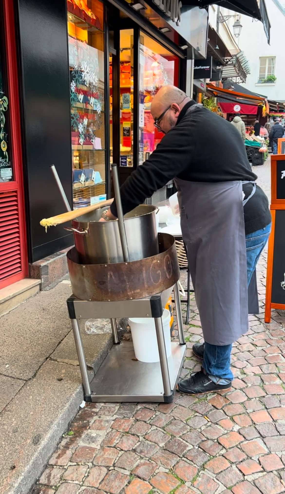 Man making cheese at the free market in Paris.