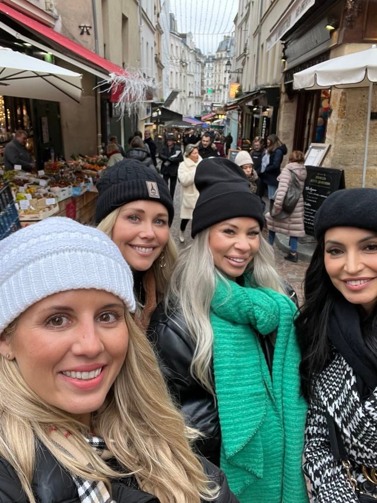 Picture of four girls standing at the free Mouffetard Market in Paris.