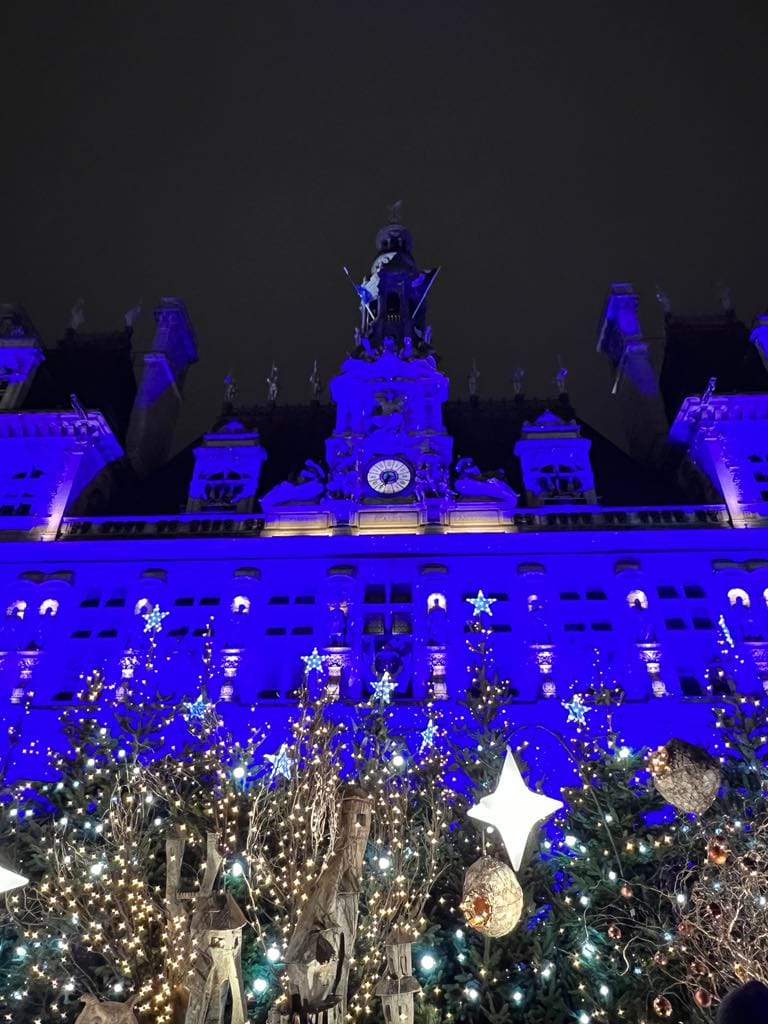 This free things to do in Paris photo is of city hall all lit up for Christmas.