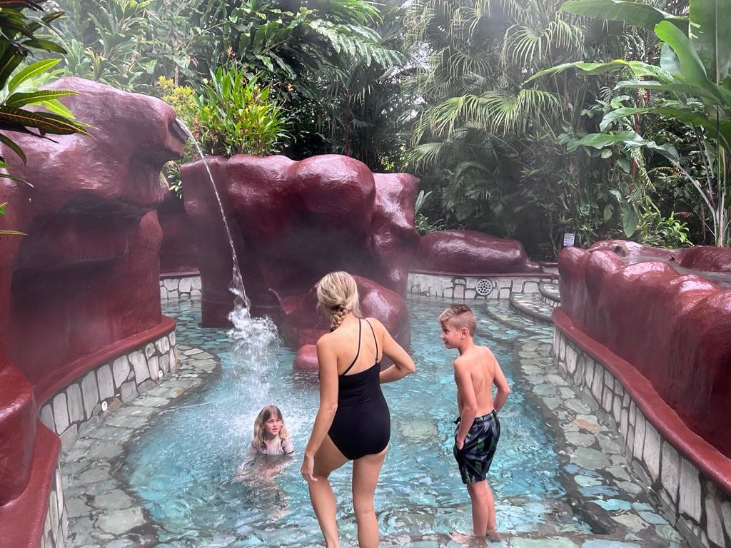 Mom and kids in a hot spring at the Baldi Resort in Costa Rica.