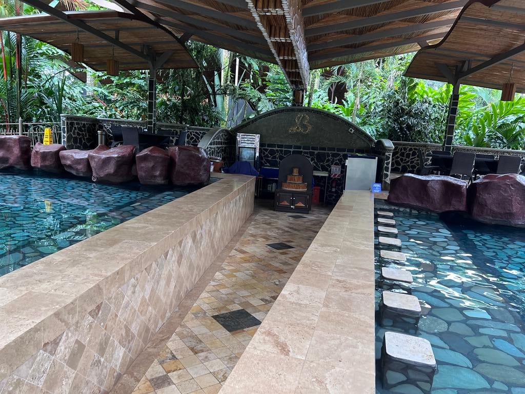 Bar inside of the hot springs pool with stone seats.