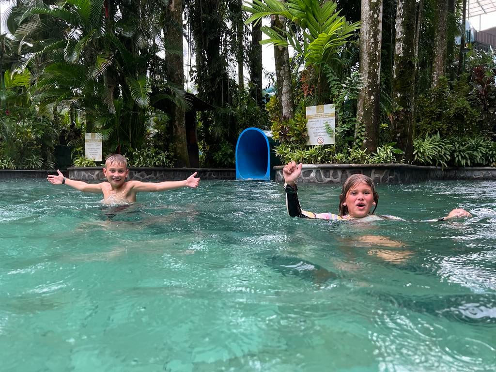 Two kids that just came down the waterslides into the hot springs at the Baldi Resort in Costa Rica.