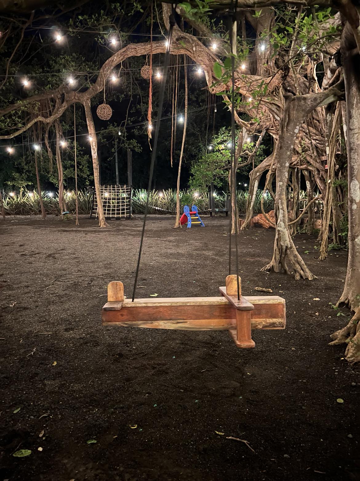 A wooden airplane swing for the kids to play on at the outdoor restaurant in Costa Rica.