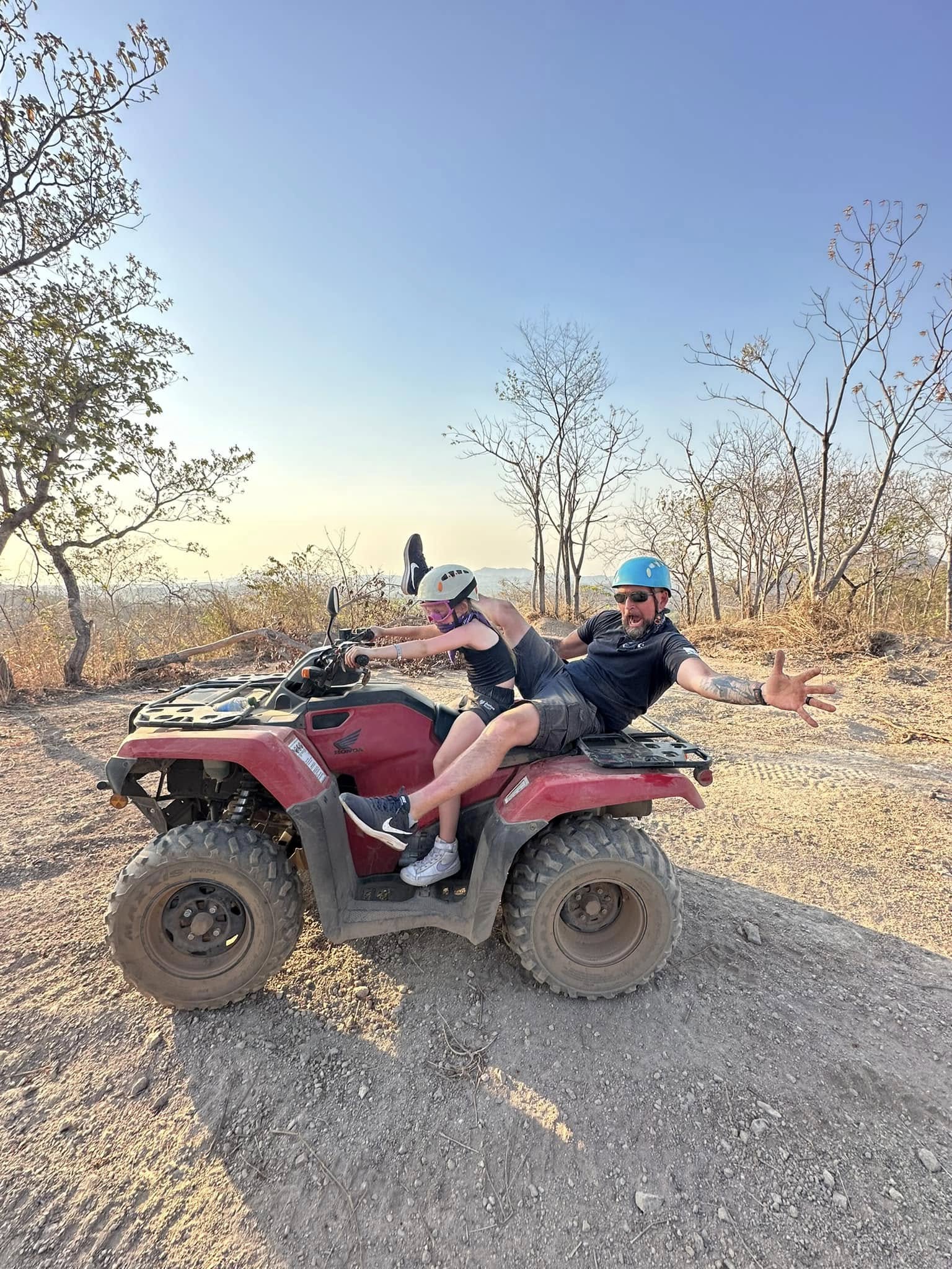 A dad and a daughter on a 4-wheeler while on a Costa Rica with kids trip.