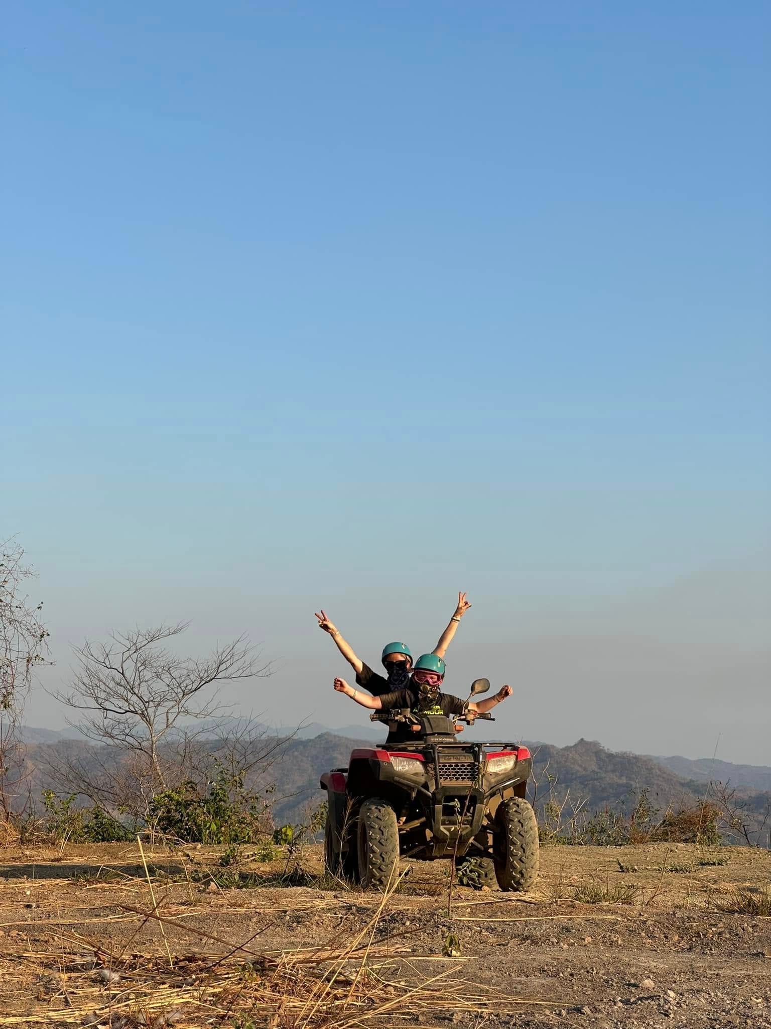 A mom and a son riding a 4-wheeler while on a Costa Rica with kids trip.