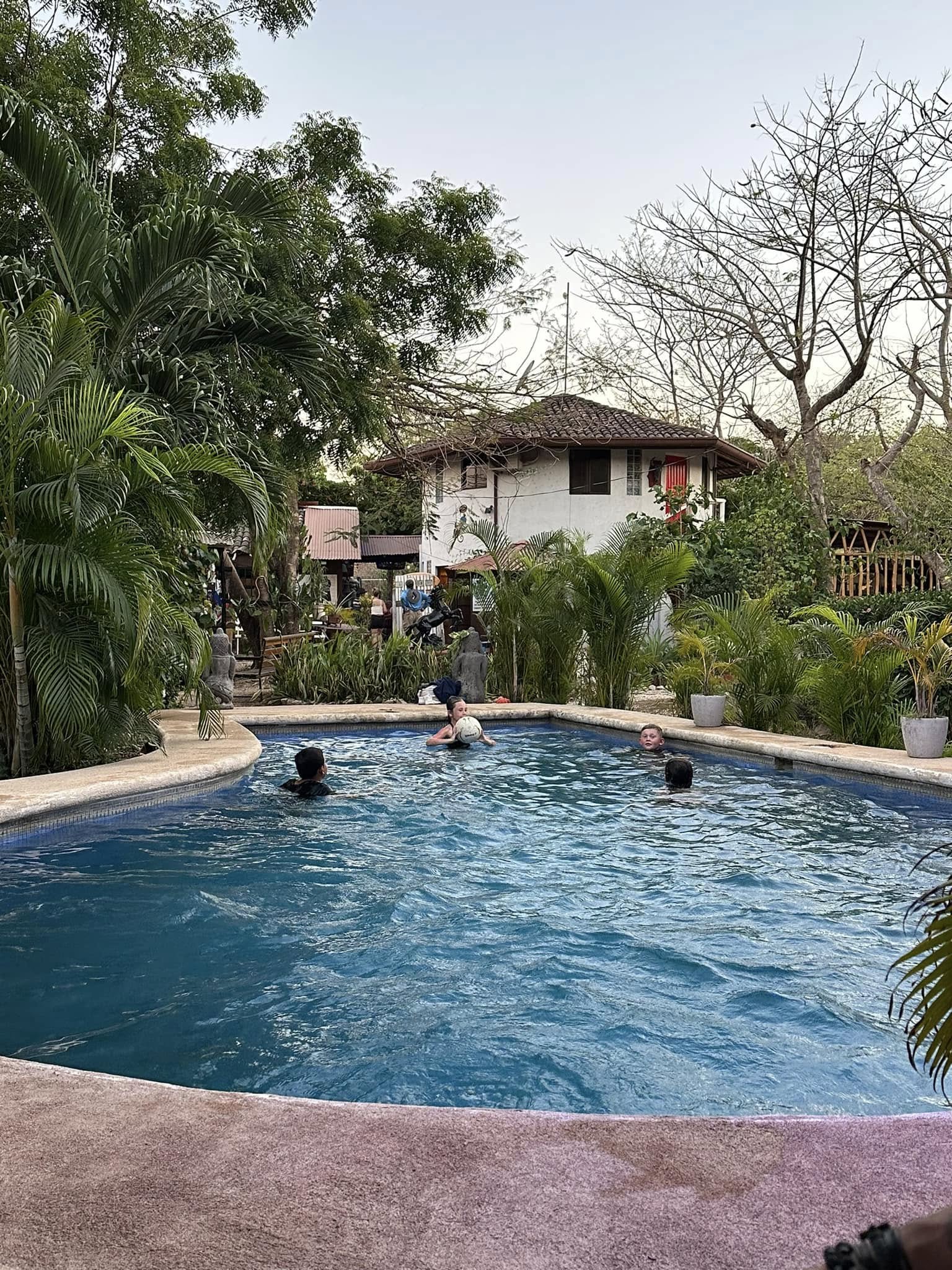 Kids in a pool after a 4-wheeling tour.