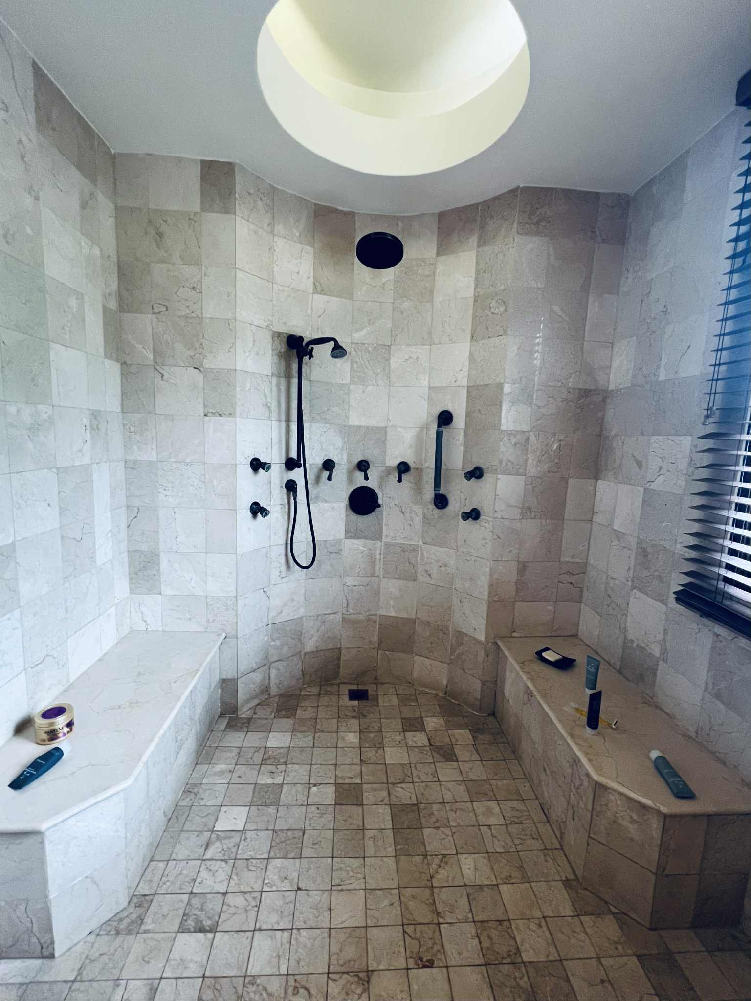A gorgeous picture of a stone shower with multiple jets.
