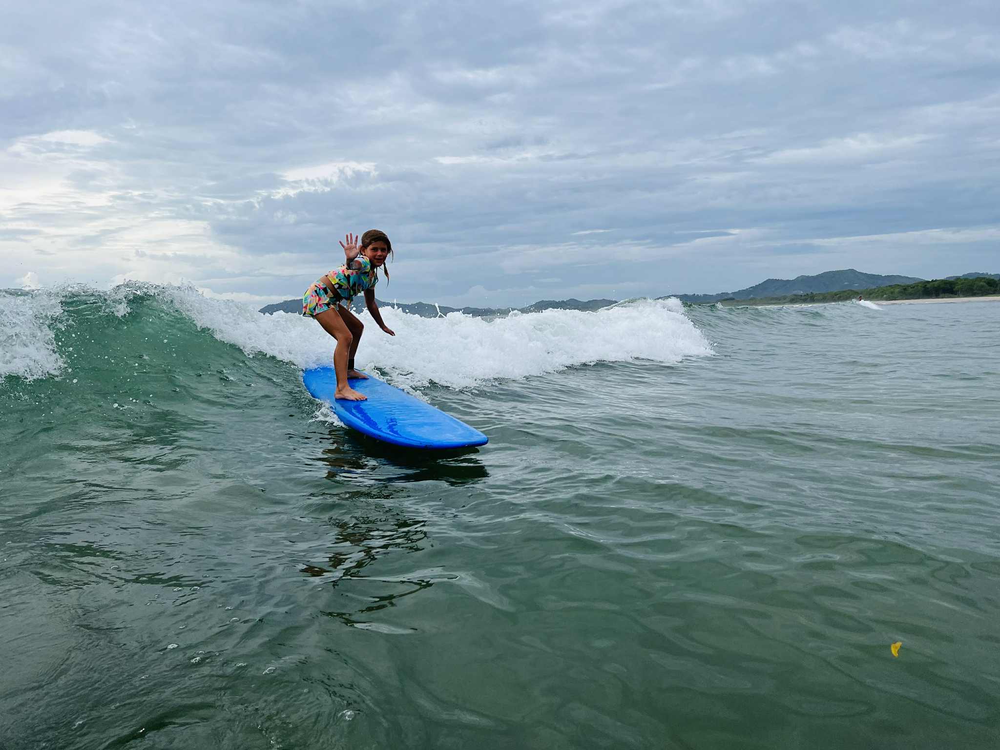 Little girl catching a wave on a Costa Rica with kids trip!
