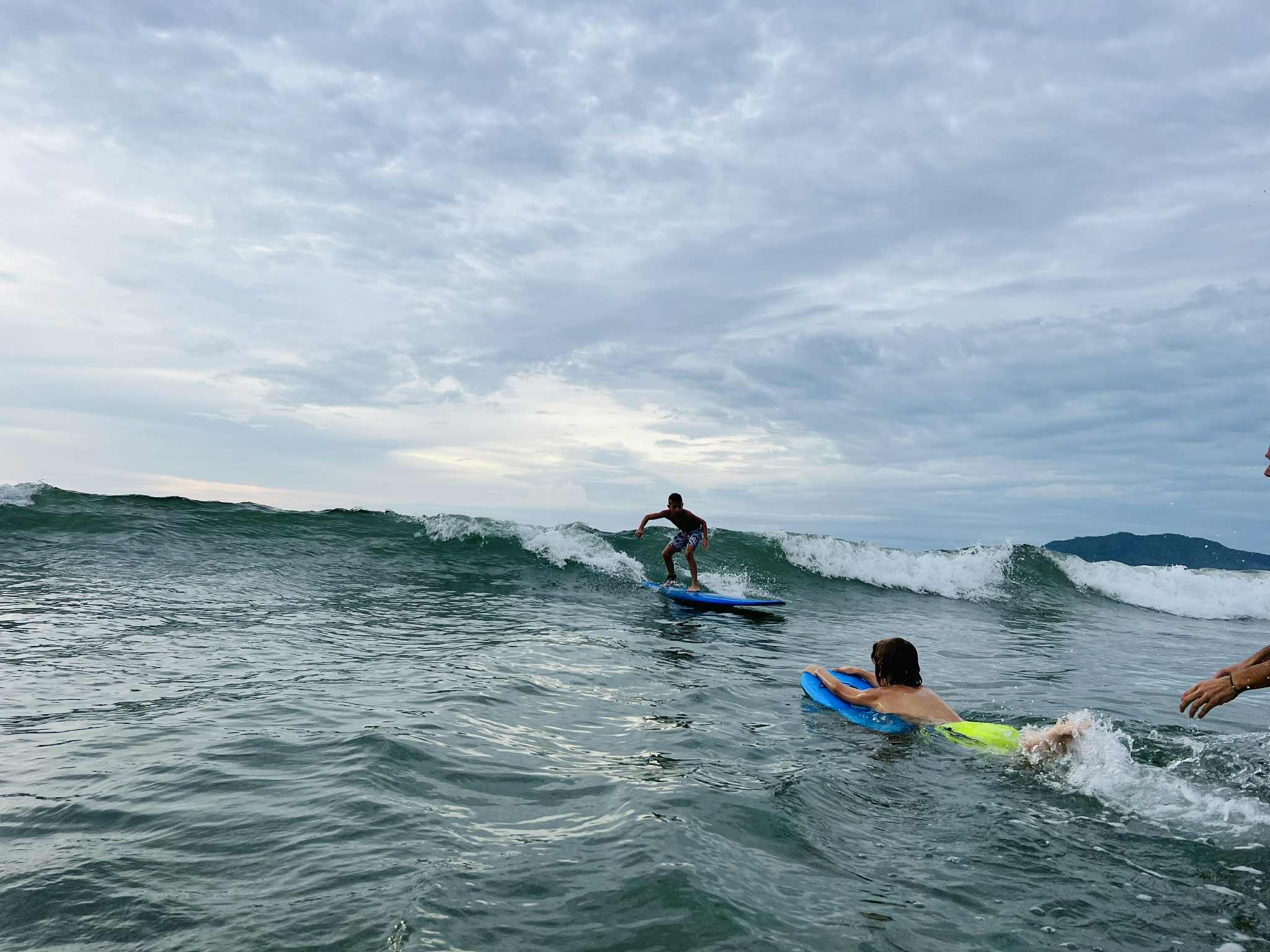 Little boy catching a wave while in Costa Rica.