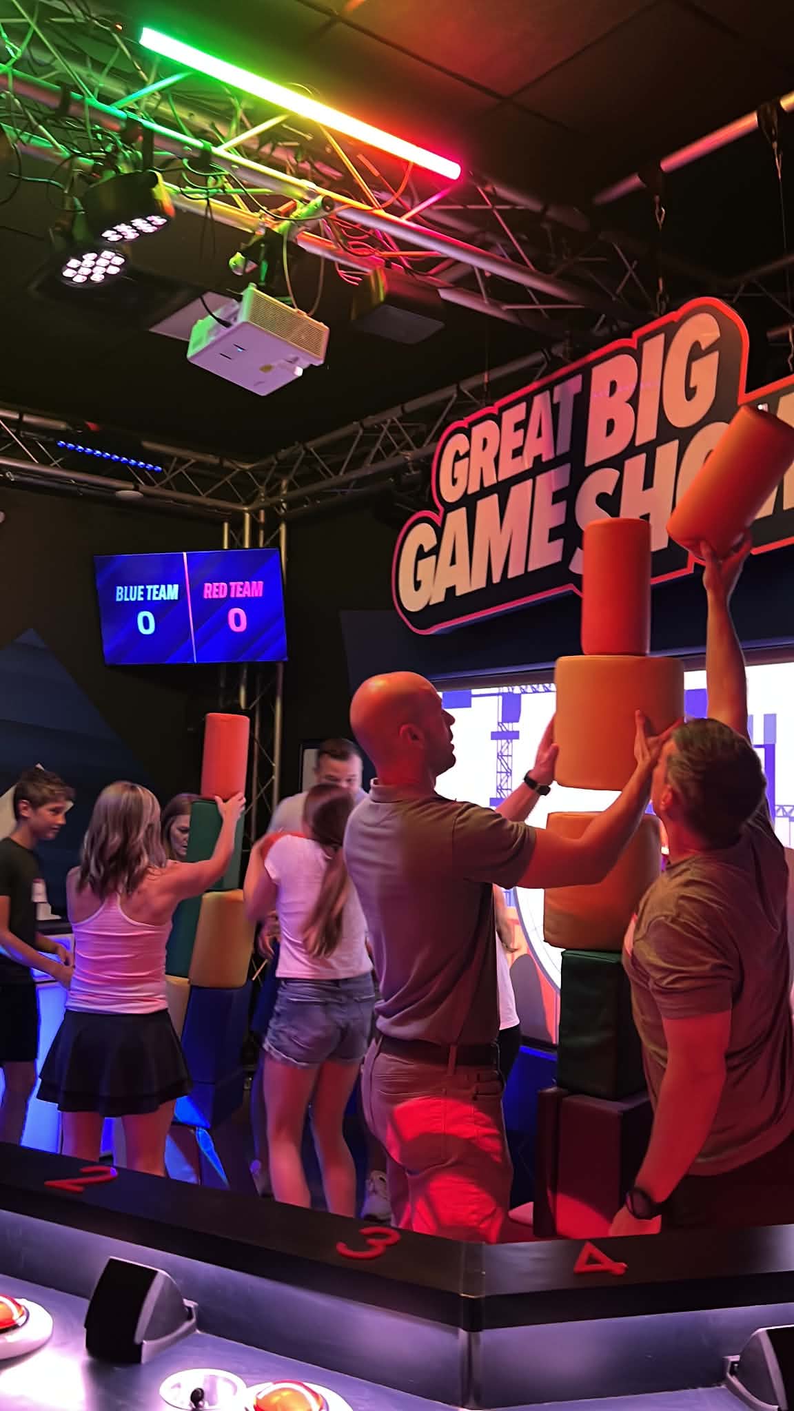 A group at The Big Great Game Show in Nashville trying to compete by stacking blocks as high as they can.