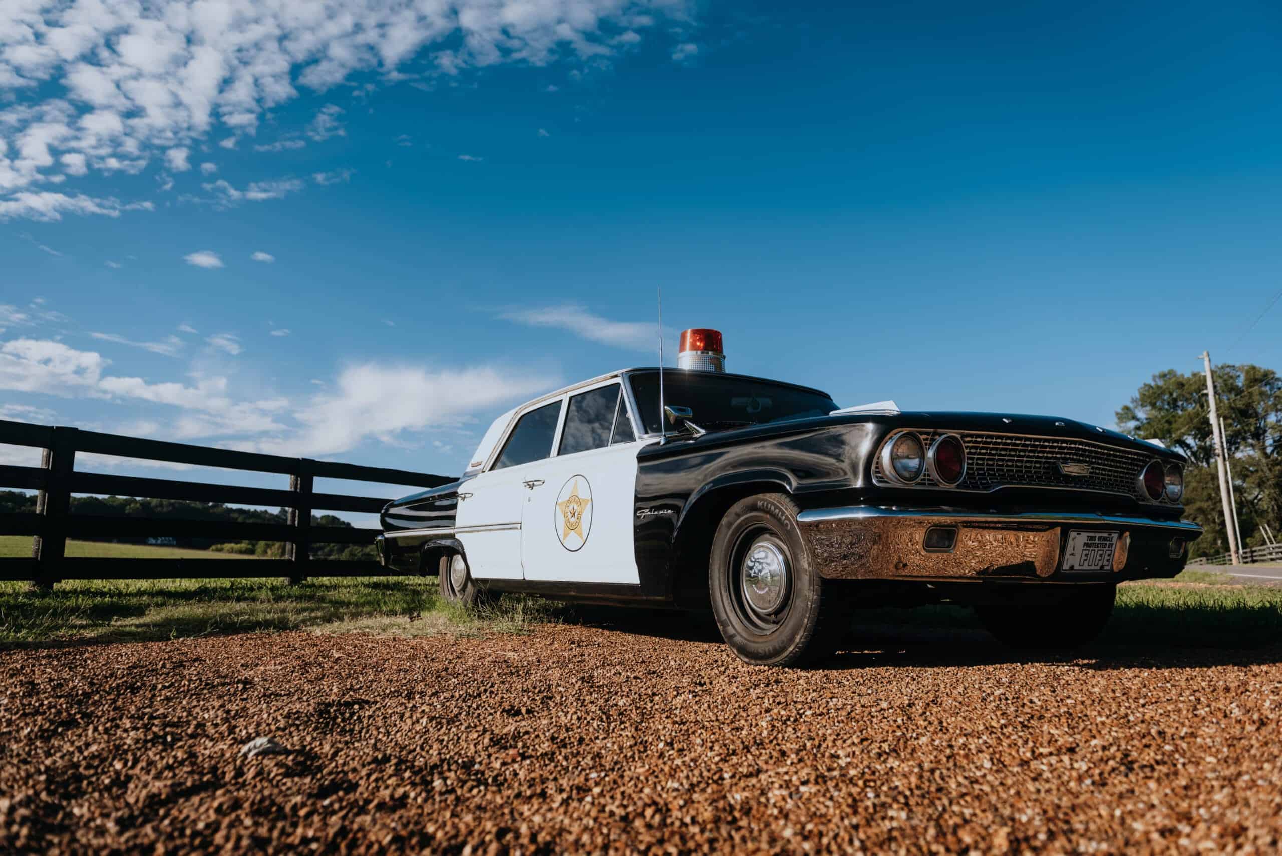 A really old cop car at the front of Leiper's Fork town.