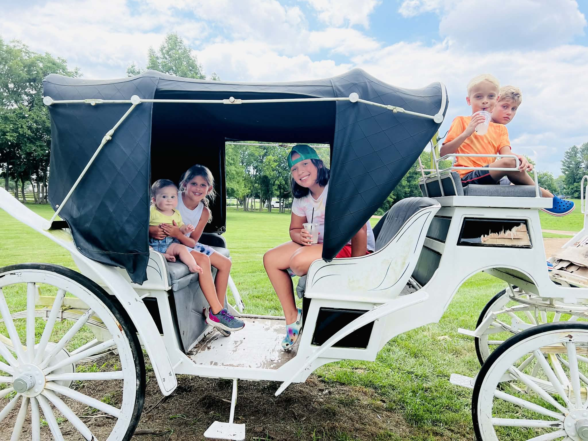 Kids playing on an old carriage in front of the coffee shop in Nashville.