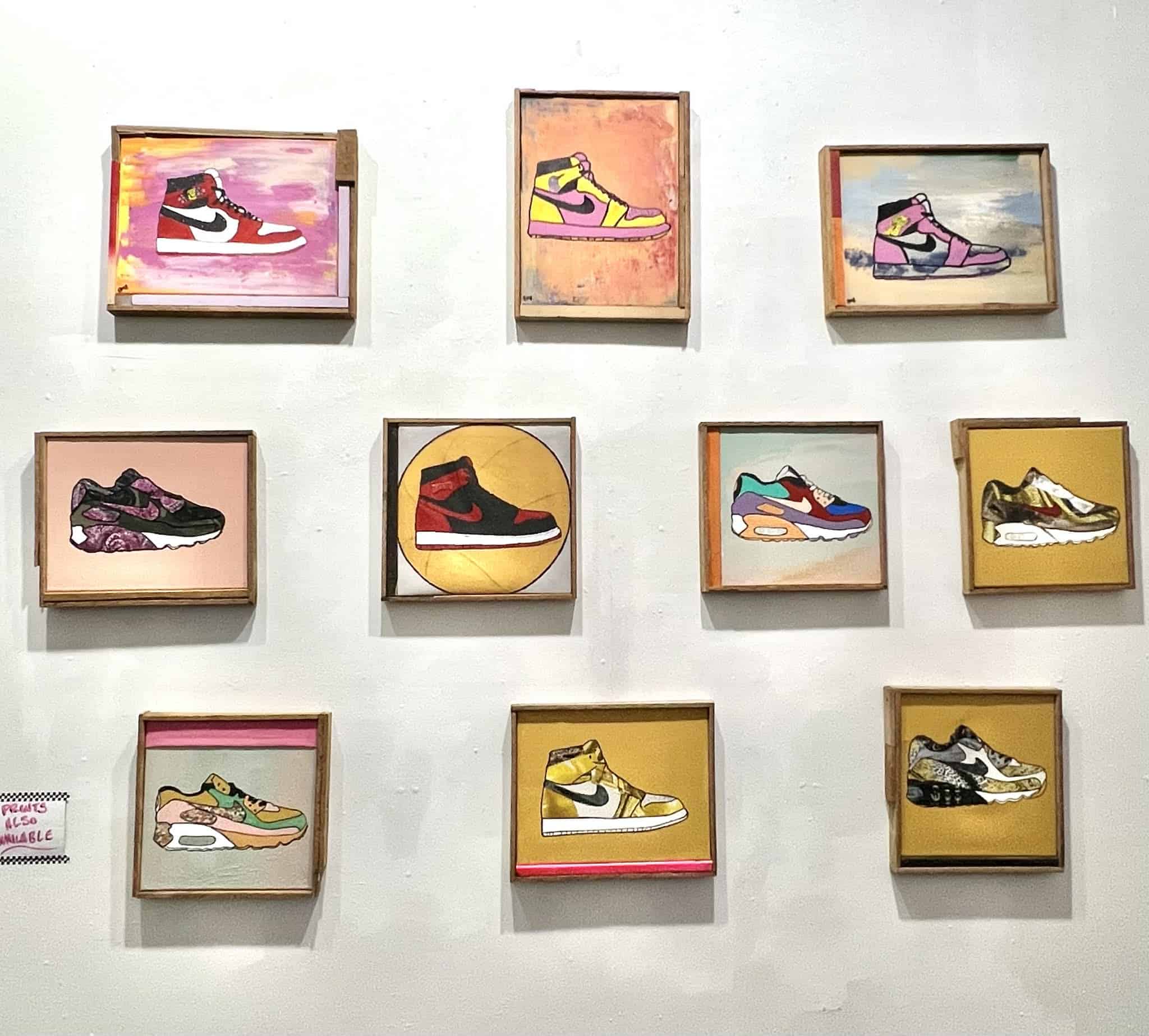 A wall of shoe art. The art is all Nike Air Max paintings.