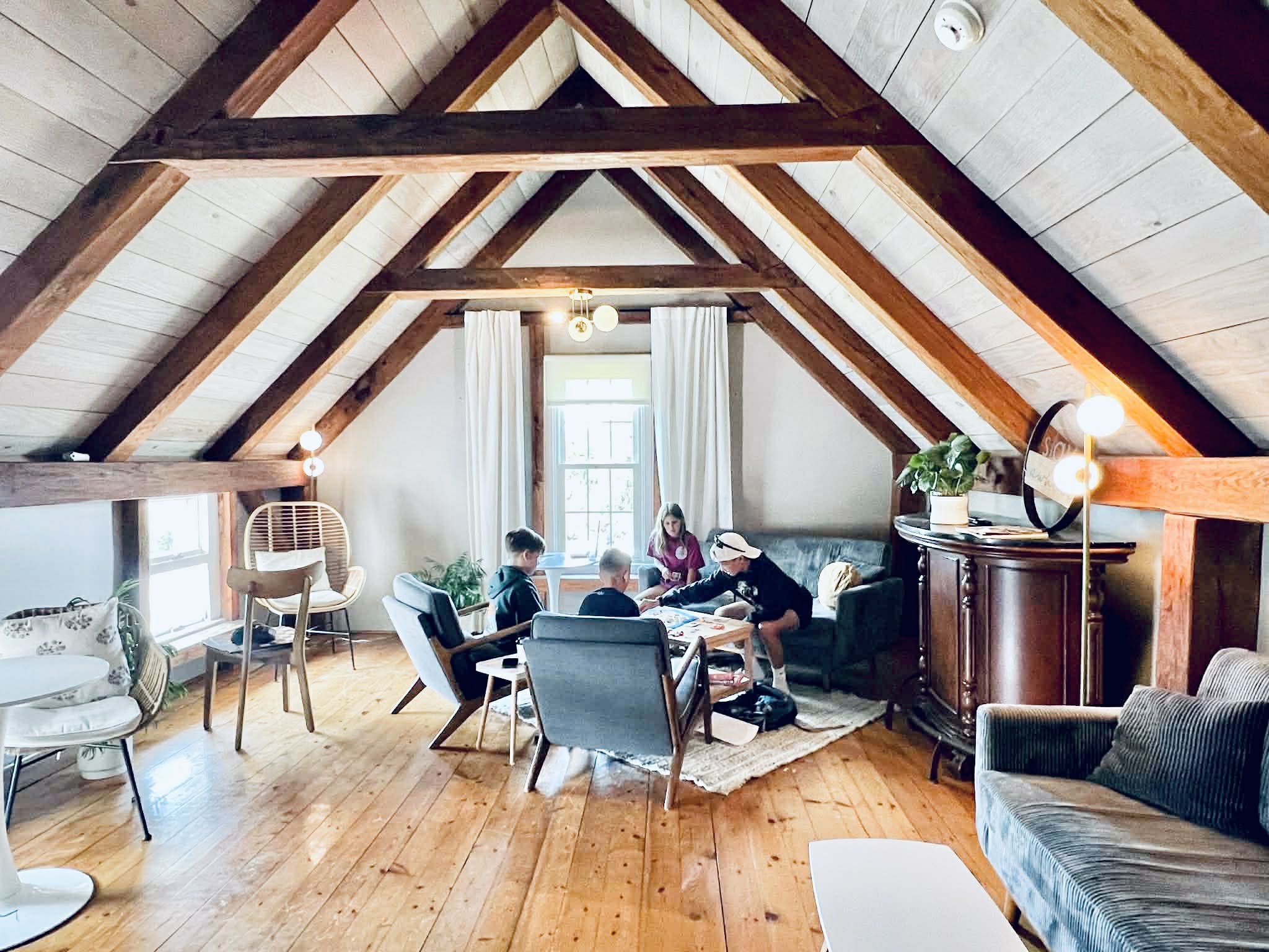 Kids playing a board game in the beautiful A lined roof upper room at the coffee shop.