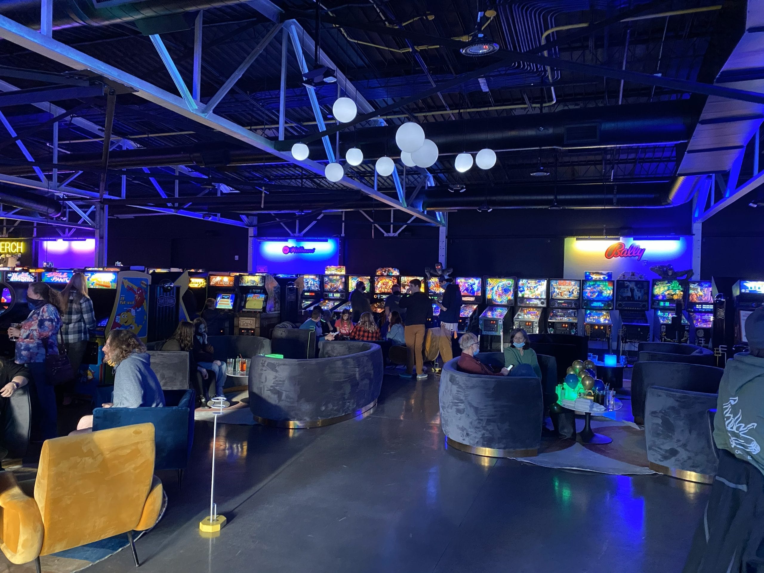 A picture of the inside of Game Terminal where there are pinball machines lined up.