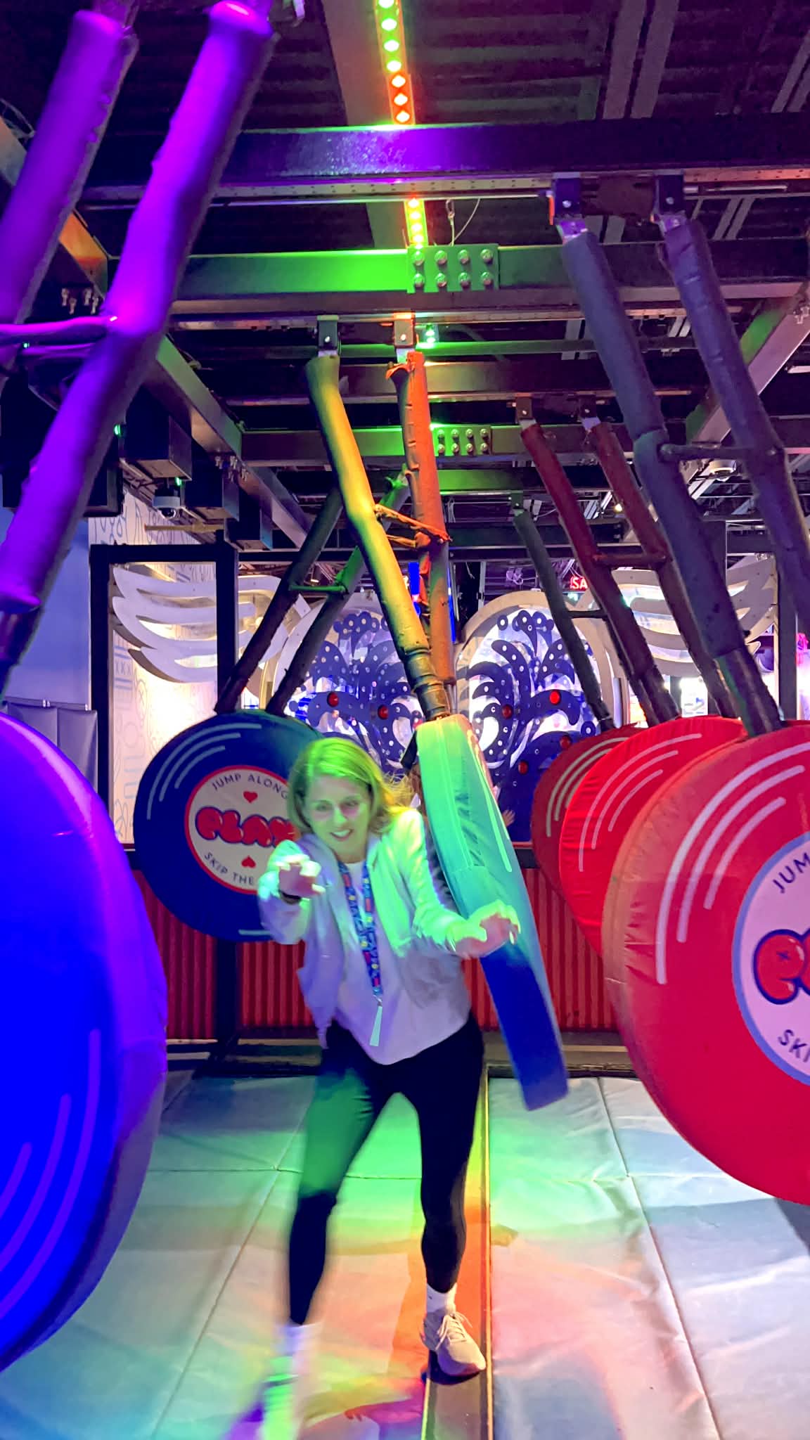 A mom trying to balance on a beam while big machines are trying to knock her off.