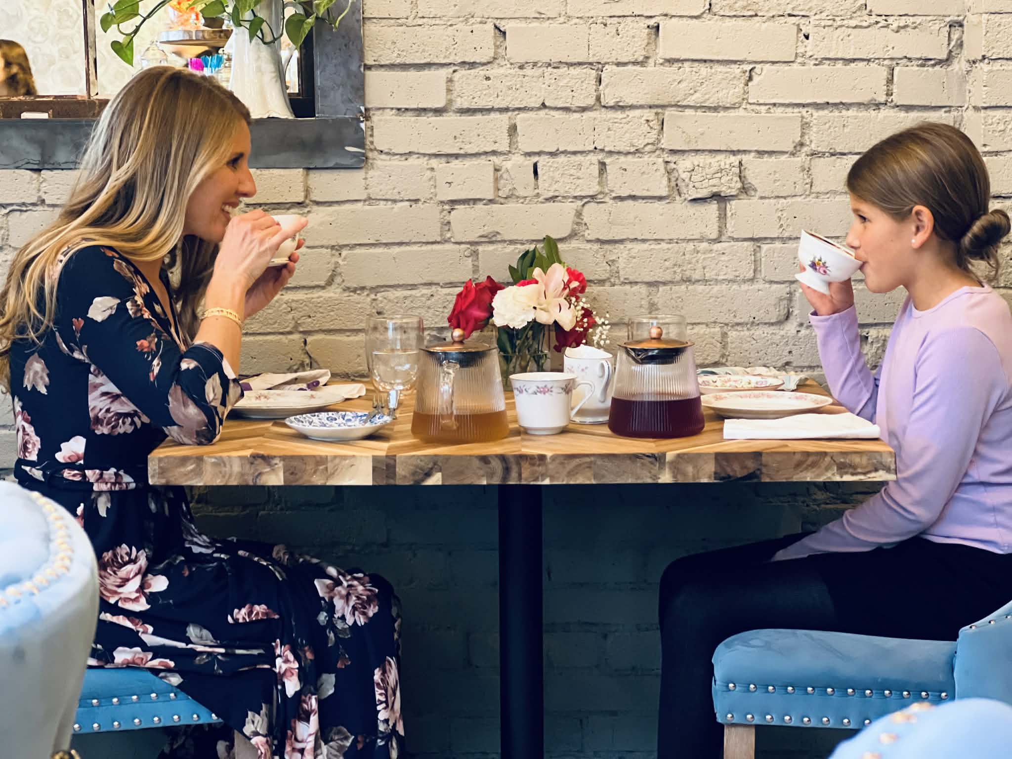 A mom and daughter having tea together at the tea room.
