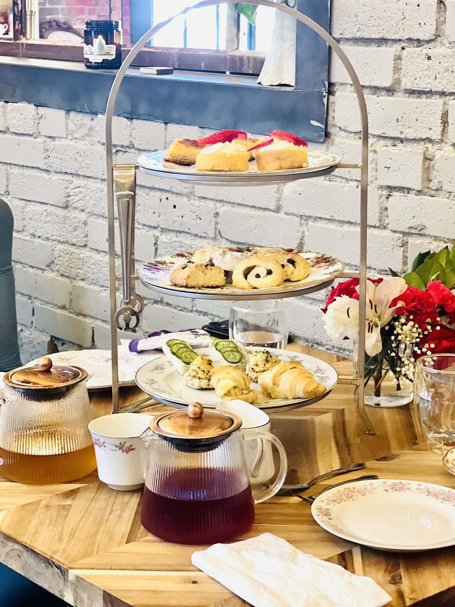 A three tiered tray of pastries at the tea room.