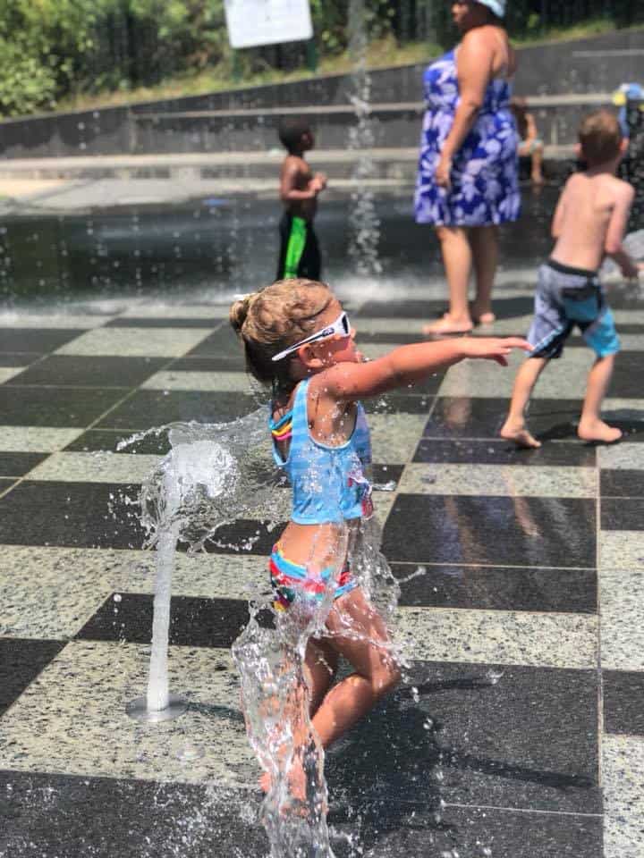 A little girl playing at the splash pad in downtown Nashville.