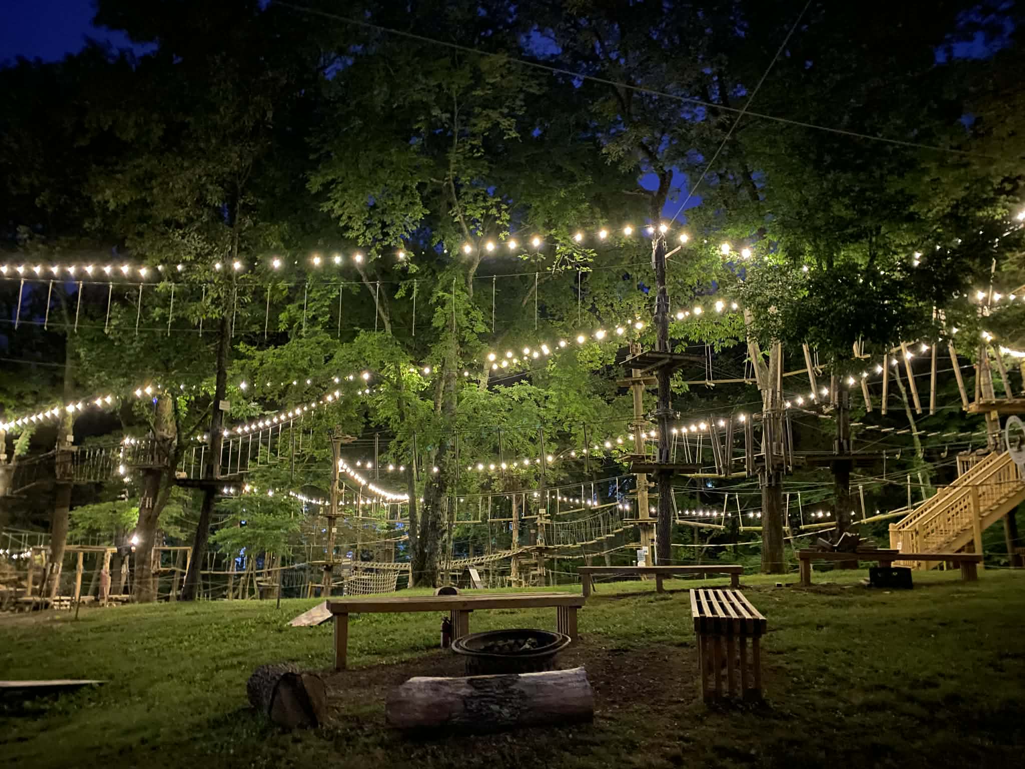 String lights all through the trees highlighting the obstacles at The Adventure Park.