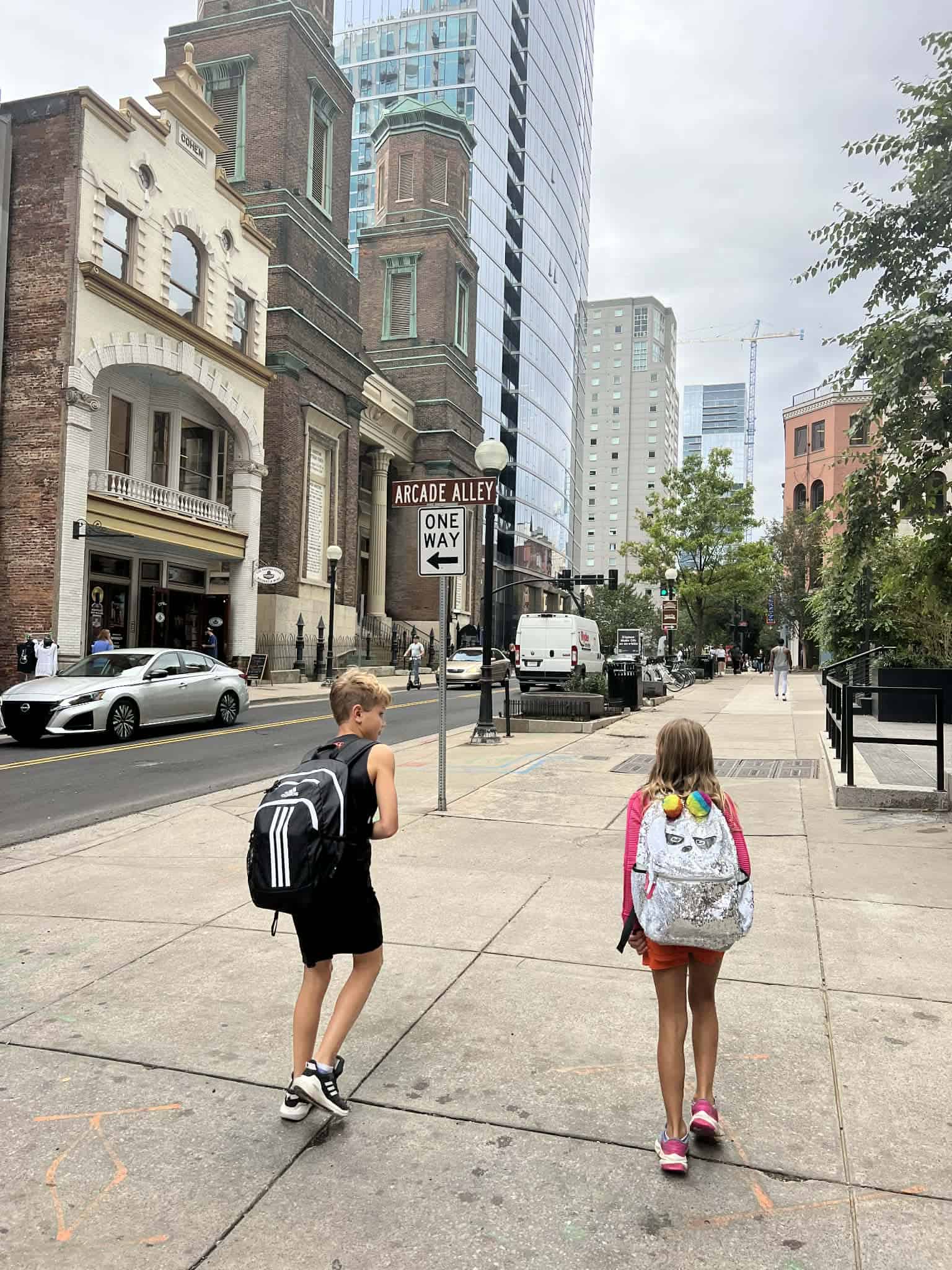 Two kids walking downtown Nashville.