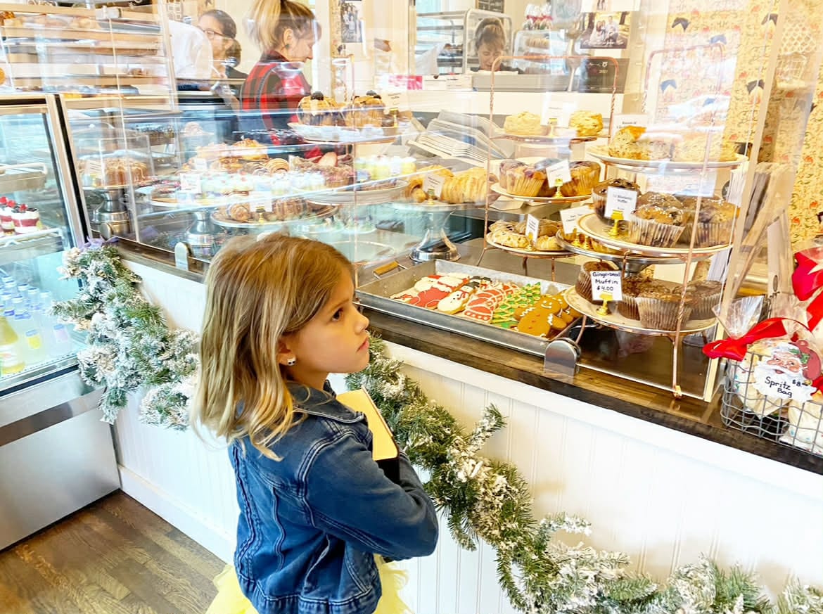 A little girl picking out her pastries at the Nashville tea room.