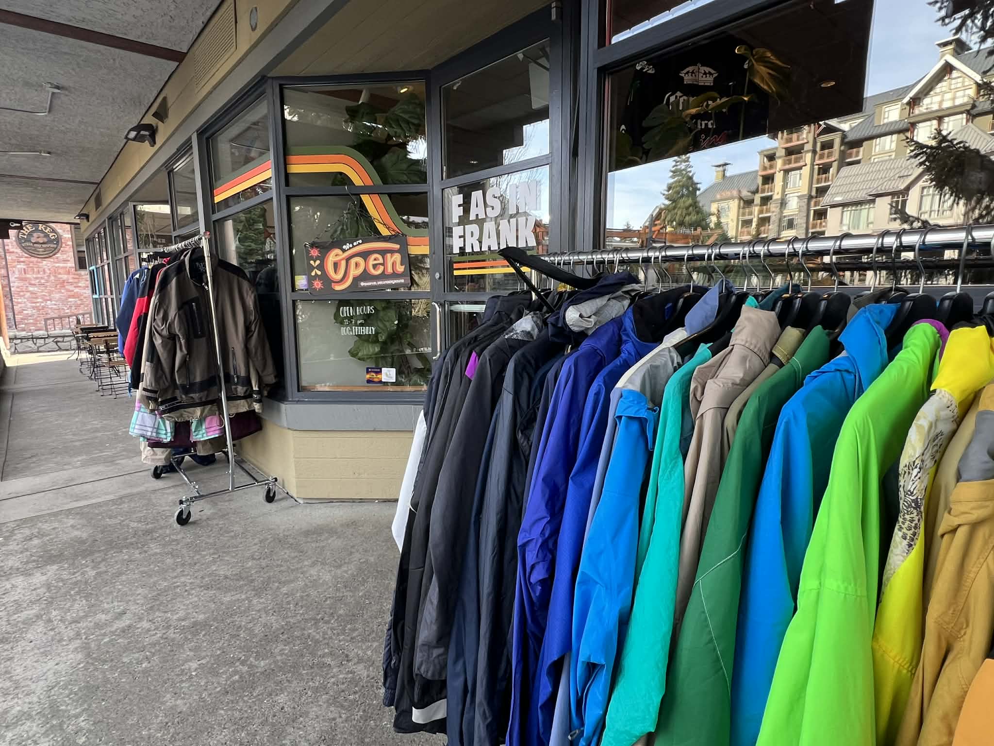 A row of colorful, vintage ski jackets in front of a Vintage shop in Whistler.