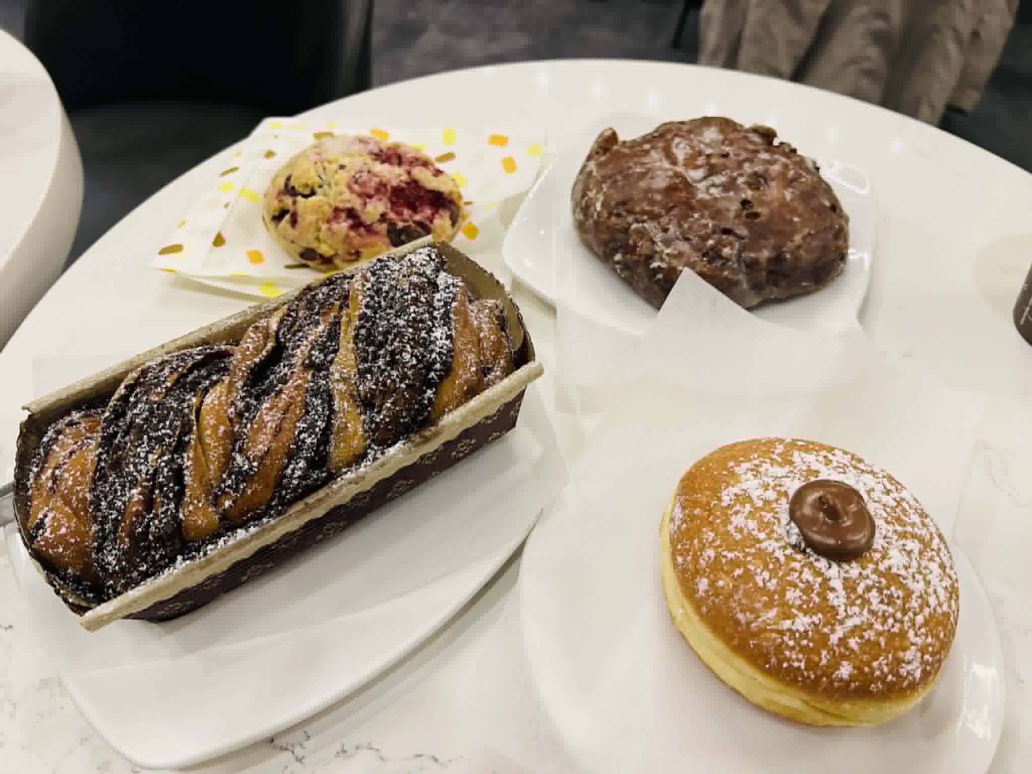 A group of 4 pastries on a table in Vancouver.