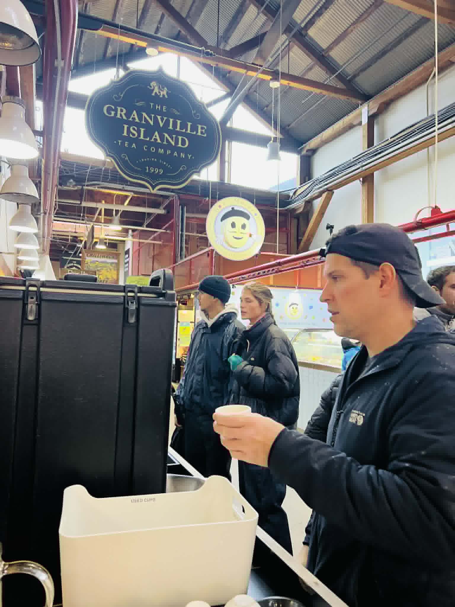 A man getting hot tea at the Granville Island Tea Company in Vancouver.