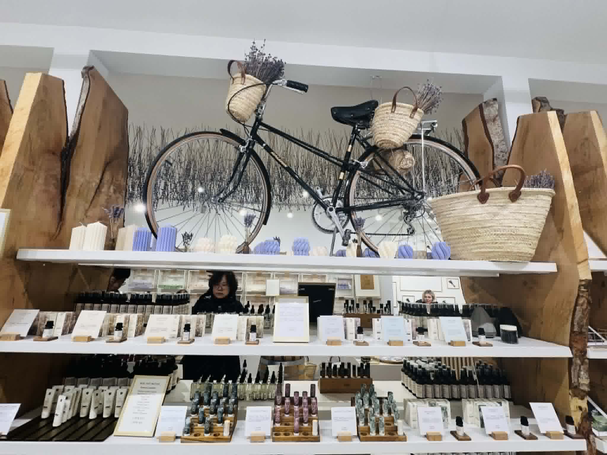 A bike with lavender coming out of the baskets at a store in Vancouver.