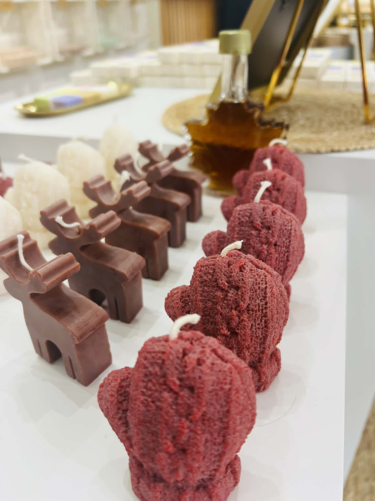 Little candles made to look like a moose and mittens.