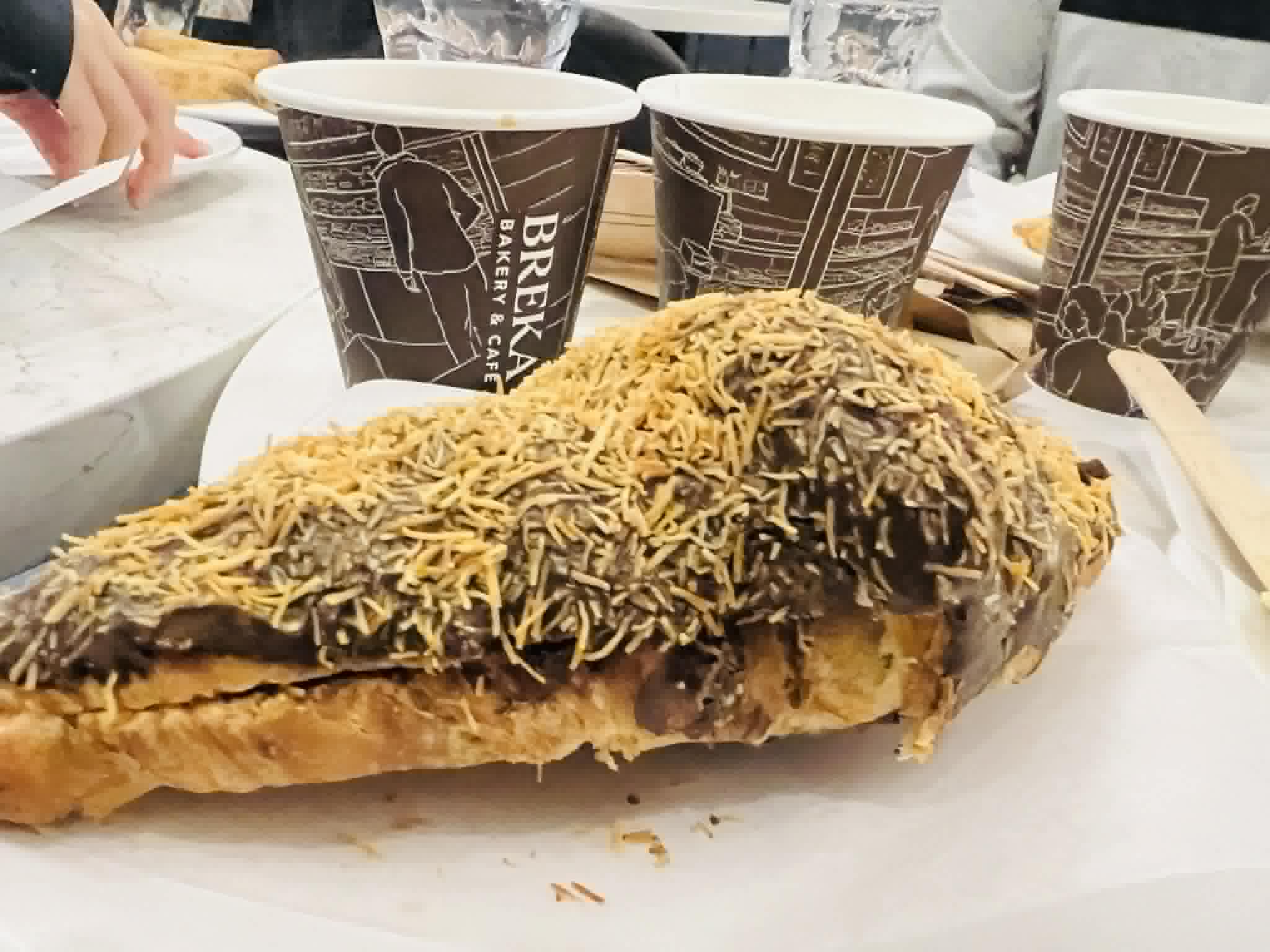 A massive chocolate and coconut croissant.